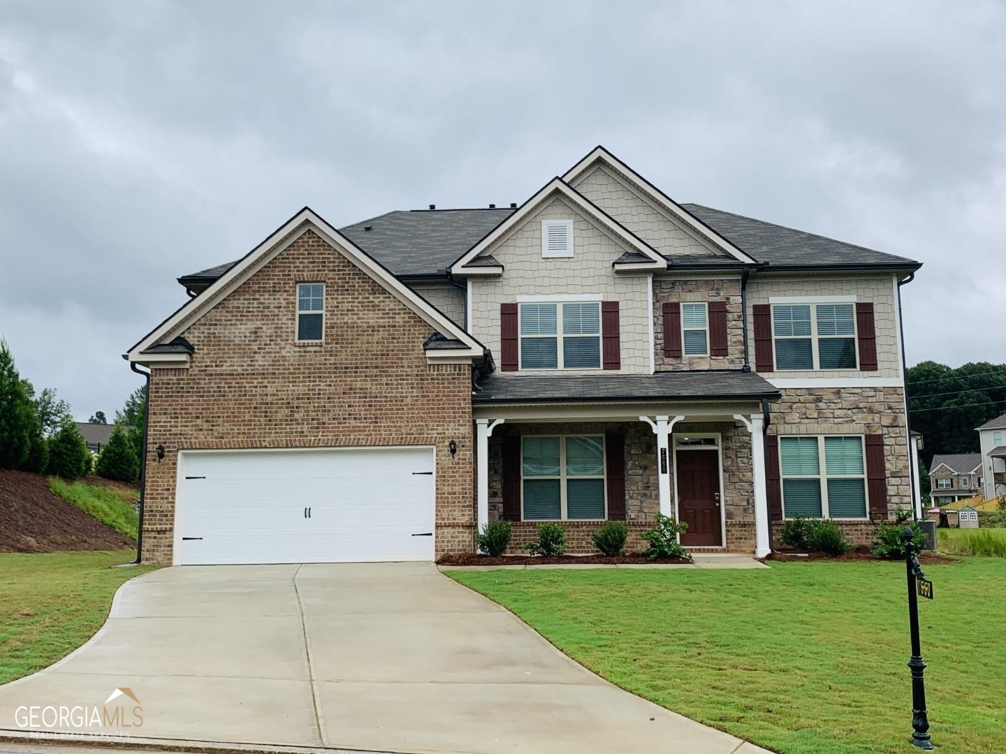 WOW! 5 bedrooms, 3 baths with a guest bedroom and full bath on the main floor. You will fall in love with the dramatic 2 story family room with ample amount of natural light. Kitchen includes 42" cabinets, walk in pantry, granite countertops and a large breakfast room. Entertain family and guest in the large loft area upstairs. THIS HOME WILL NOT LAST LONG. Highly sought after Forsyth county school district. Neighborhood amenities include a swimming pool, cabana and playground, must see!