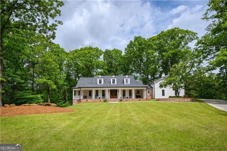 Nestled in the heart of Milton, Georgia, just three miles from the vibrant downtown Alpharetta, this stunning custom farmhouse is a true masterpiece. Situated on a private, expansive two-acre lot, this builder's own home blends timeless craftsmanship with modern luxury. Boasting five spacious bedrooms and five and a half beautifully appointed bathrooms, this residence is designed for comfort and sophistication. The main level features a serene master retreat, while an additional master suite above the garage offers privacy and versatility. Throughout the home, heart of pine floors exude warmth and character. Entertain effortlessly in the chef's kitchen, complete with top-of-the-line Wolf and Sub-Zero appliances, perfect for culinary enthusiasts. The finished basement adds even more space for recreation, relaxation, or hosting guests. Step outside to the breathtaking covered porch, where a striking craftsman-style stone fireplace sets the stage for cozy evenings. Whether you're sipping morning coffee or enjoying an alfresco dinner, this inviting outdoor space is a dream. The charming rocking chair front porch, adorned with an elegant brick herringbone pattern, offers a warm and welcoming entrance, perfect for peaceful afternoons spent enjoying the scenery. Luxury, privacy, and timeless charm-this Milton farmhouse is more than a home; it's an experience. Don't miss the chance to make it yours!