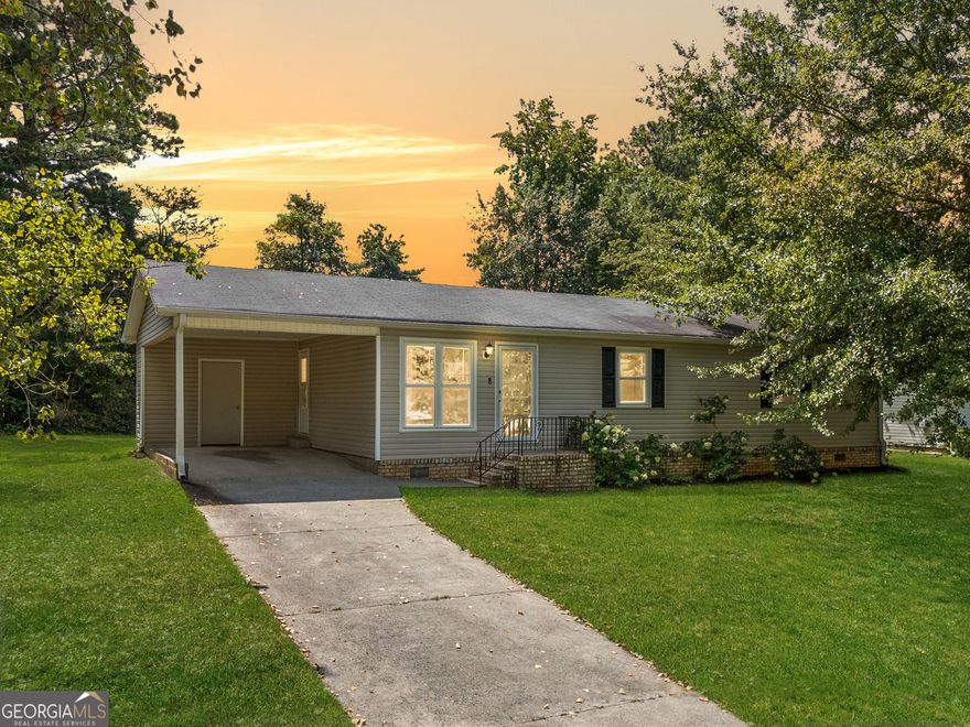 Tucked at the end of a quiet cul-de-sac, this move-in ready ranch delivers easy, practical living on a private lot without the hassle of a homeowners association.  Step inside to find a bright, open layout where the living room flows directly into the dining area and kitchen. The kitchen is outfitted with dark wood cabinets, low-maintenance countertops, and black appliances, including a gas range and side-by-side refrigerator. Durable tile underfoot transitions seamlessly to warm hardwoods in the living space, and sliding glass doors open to a back deck, perfect for outdoor meals or morning coffee.  Three bedrooms sit down the hall, along with one and a half baths. Need extra room? A dedicated flex space near the entry works well as a home office, den, or creative studio.  Out back, a large detached shed with upper loft space offers tons of potential, whether you're storing gear, starting a workshop, or need extra room for hobbies. There's also a covered carport and off-street parking.  Located near shopping, dining, and major roads, but without the noise. Whether you're taking your first step into homeownership or just want something easy to maintain, this one checks the boxes.