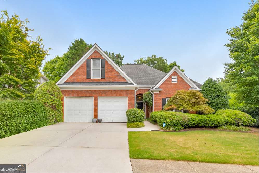 Here it is! The perfect home your family has been looking for! Welcome to this meticulously maintained 4 bed / 3.5 bath ranch home, perfectly situated in the sought-after St. Charles Square swim/tennis community in East Cobb. Step inside to an inviting foyer that opens to a fireside living room with vaulted ceilings and a built-in entertainment center with bookshelves. The elegant kitchen features granite countertops, a JennAir gas cooktop, breakfast bar, and a sunny dining area. The spacious primary suite showcases tray ceilings, his-and-hers closets, and a beautifully updated bathroom with dual vanities, a luxurious shower, and a bench seating area. Two additional bedrooms on the main level share a lovely bathroom. Upstairs, a private bedroom with a full bath and walk-in closet offers the perfect space for guests, a home office, or bonus room. Additional highlights include plantation shutters throughout, newer LVP flooring, and a Generac whole-house generator. Enjoy a private, fenced backyard with a patio and serene water feature. This home is perfectly situated across from the community pond and nature trail, and also has access to the neighborhood pool, tennis courts, and playgrounds. Don't miss your opportunity to make this delightful home yours!