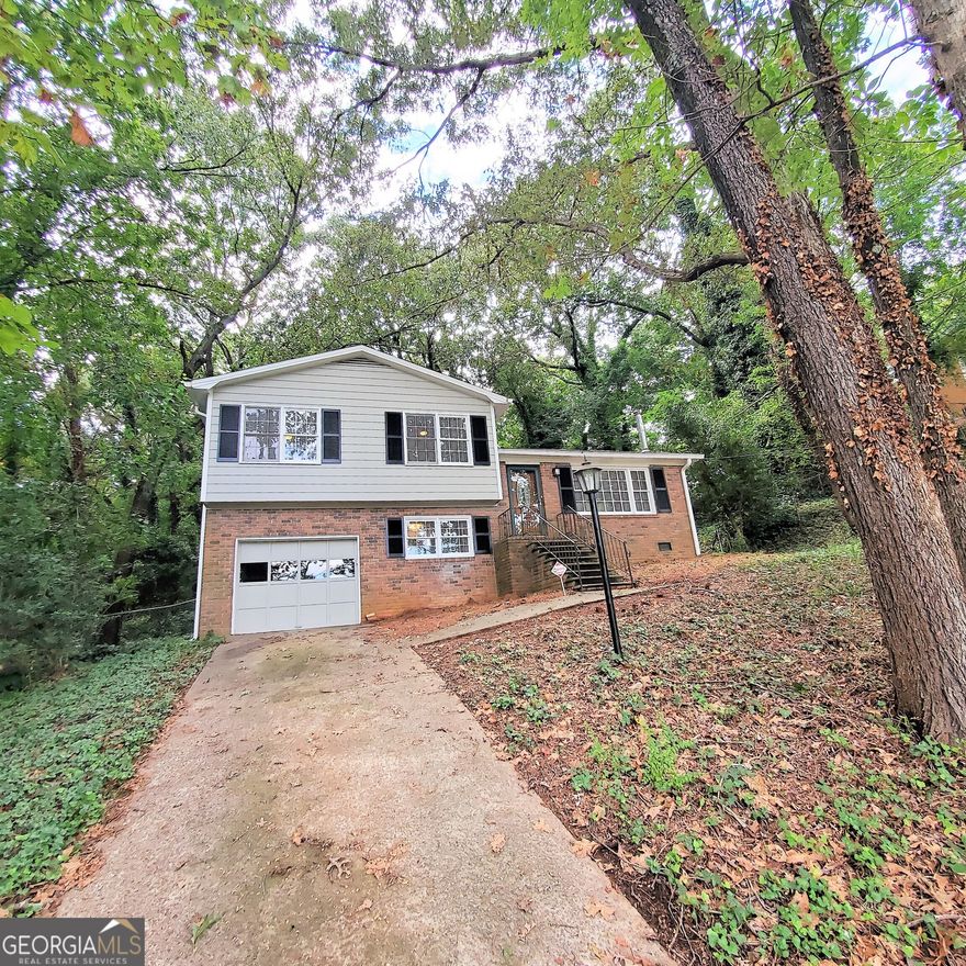 Beautiful 3-Bedroom Private Split Level with Garage, Bonus Room, Fenced Backyard, Low Maintenance Wooded Lot, Huge Deck, Sparkling Hardwood Floors, Decorative Only Wood Burning Stove, Large Laundry Room. Only 2 Minutes from I-75. Walking distance to Park with Lighted Tennis Courts, Walking Path, and Playground! Quiet Neighborhood. Move-in Ready! This is a Must See!  PROPERTY AVAILABLE RIGHT NOW!!