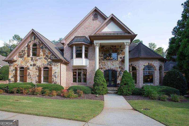 Don't miss this BEAUTIFUL HOME with an AMAZING Clear VIEW OF GOLF COURSE!!! Hole 13, 14, and 15 in your backyard! Driving up to this brick and stone manor, you can pull right around to the front door on the curved driveway; or park your car in the large three car garage. Step up to covered entry flanked by large columns; and walk through grand iron & glass doors, greeted by a two story foyer with a beautiful chandelier, travertine floors leading to a fabulous curved iron staircase. From the foyer are spacious living areas that flow easily from room to room. Formal dining room, service bar, living room, study/flex-room, kitchen, family room and family dining area. Also a large bedroom and full bathroom on the main level. Walking through on Brazilian Cherry floors in all of these rooms. This home is full of Extras not to miss!! The formal dining room and living room have cove lighting in trey ceilings. Family room has beamed vaulted ceiling, and floor to ceiling stone wood burning fireplace. The living room has a Victorian era gas fireplace. All rooms facing the back have the amazing golf course view. Picture windows throughout. Kitchen has large breakfast bar, island with prep sink, granite counters, custom hood, uplighting and under cabinets lighting, top of the line stainless appliances, Sharp microwave drawer, built in Monogram refrigerator, separate entry from side porch and from garage. Plus a door out to a huge covered balcony. The study/flex room is massive with French window and a wall of glass doored closets, ready to fit your family needs. Through out the home you will find high ceilings, crown molding, dual zoned air conditioning, and central vacuum system with built in kitchen dust pan. Bathrooms with granite, travertine, and marble. As you come up the stairs of the curved staircase to the Upper level you will come to an open area; that steps up to another large family room/flex space. Just down the hall you will find the Primary bedroom suite, with a sitting area overlooking the golf course, gas fire place and the beautiful Brazilian cherry floors. From there enter into the primary bathroom with double vanities and a sitting vanity area, with marble counters, large shower, large soaking jacuzzi tub, private toilet, and two walk-in closets. You will also find two sizable secondary bedrooms with ensuite bathrooms, and a conveniently located laundry room. The Terrace level has more sensational views of the golf course, 11 foot ceilings, crown molding, custom wood beams, large two sided stone wood burning fireplace, beautiful designer exposed brick walls, wine cellar, large pantry/finished storage area, huge entertainment space with kitchen and bar, large bedroom with full bathroom, and bonus finished space for a movie room (sound proof) or more storage. Walk out to a covered terrace and flat back yard with sprinkler system. The yard is perfect for adding your own private pool. You could walk straight out to the Green. MAKE THIS DREAM HOME YOURS! Polo Golf & Country Club has a very reasonable HOA. The Country Club membership is optional and has several levels available.