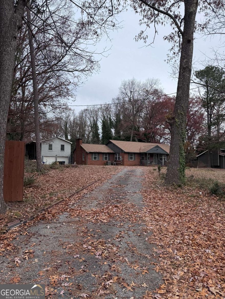 Spacious brick ranch on a huge lot. Amazing opportunity to renovate or build your dream home on a 1.6-acre property that features fruit trees and privacy with room for a pool and tennis court! All this in a top-notch location of Marietta. 2 car garage with 1/1 apartment above it needs a bit of work. Or potentially subdivide the lot and build multiple homes!  SOLD AS IS !!