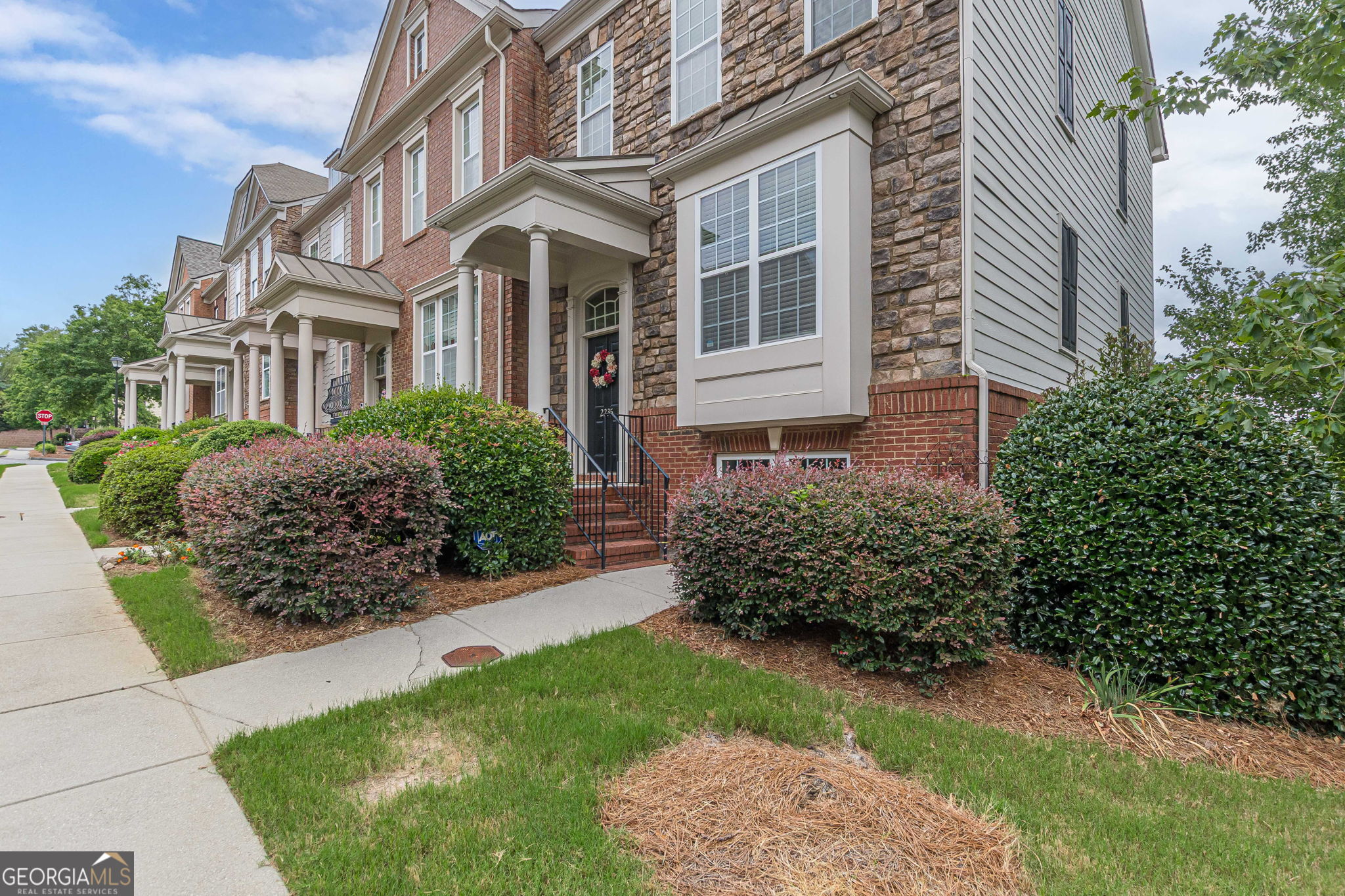 This spacious end-unit townhome offers comfort, privacy and quiet wooded setting. The main level features an open-concept living and dining area, a well-appointed kitchen, and access to a private deck-prefect for relaxing or outdoor dining. Upstairs two generously sized bedrooms offer flexible options for a primary suite. The terrace level includes a versatile third bedroom with a full bath, ideal for a guest suite, media room or home office. The community features a sparkling pool and ample parking space. Located just minutes from Truist Park, The Battery, Smyrna Market Village, West Midtown, Reservoir Park, the Silver Comet Trail and so much more!