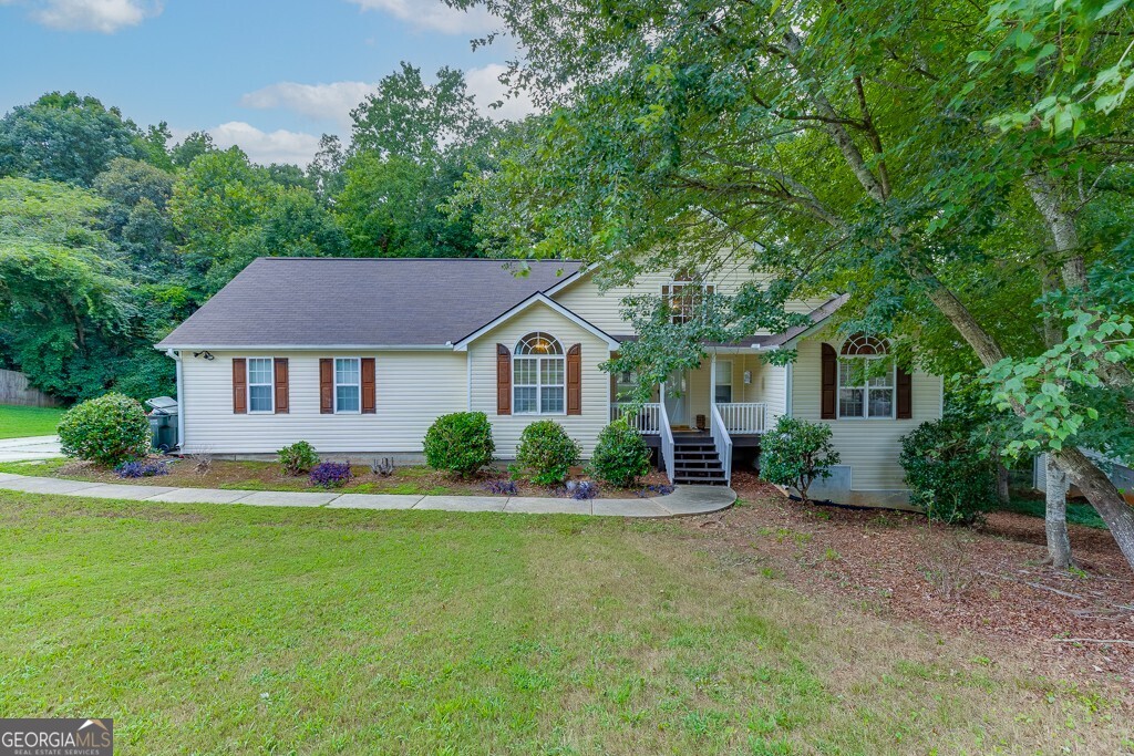 FULLY RENOVATED RANCH home with full FINISHED terrace level! Welcome to this fully renovated ranch on a finished basement in the heart of Loganville. Step inside to find luxury vinyl plank flooring throughout the main level and a beautifully updated kitchen with quartz countertops, white cabinetry, stainless steel appliances, and a walk-in pantry, all open to the vaulted dining room and spacious family room. The split-bedroom layout offers privacy, with an oversized primary suite featuring a stunning tile shower, dual vanities, and a separate soaking tub. Two additional bedrooms, a full bath, and a convenient laundry room complete the main floor. Downstairs, the finished terrace level is perfect for extended family or guests, with a full kitchen, dining area, den, a second primary suite with walk-in closet, second laundry and private bath, plus an additional bedroom or home office. Enjoy a private entrance to the terrace level and a charming, low-maintenance backyard. This one checks all the boxes space, style, and flexibility!