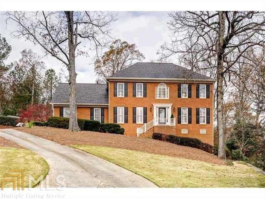 Amazingly beautiful, custom plaster mouldings in this 5 bedroom, 4 baths brick home on culdesac setting,nearby wonderful public & private schools,shopping & parks. Hardwood floors throughout,sep living,dining & firelit family rooms. The gourmet eat-it kitchen-has SS appliances, double ovens & warming drawer, with views to priv. backyard & Brazilian walnut IPE deck. Guest suite on main. Upstairs master with custom closet & spa like bath, and addl.3 bedrooms /office. Finished,fireside terrace level,custom wet bar, builtins,bath,shelved storage room, & exterior entry.