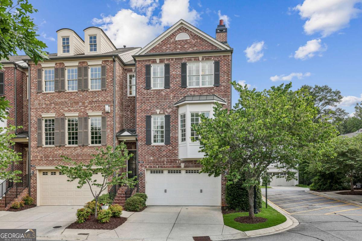 Nestled in the heart of Alpharetta's vibrant downtown Garden District, this bright and airy brick end-unit townhome offers unbeatable access to the city's top amenities. Just a short stroll away, you'll find an array of local restaurants, charming shops, outdoor concerts, and the Farmer's Market everything you need right at your doorstep. This beautifully appointed townhouse offers privacy, space, and convenience in equal measure. Featuring four generously sized bedrooms and three-and-a-half bathrooms, this home delivers comfortable living in a vibrant community setting. Step inside to discover a flexible layout with bright, open concept living areas ideally suited for both relaxed evenings at home and weekend entertainment. The bright white custom kitchen features stainless steel appliances, under cabinet lighting, marble countertops, backsplash and a spacious island which flows seamlessly into a warm and inviting living area, highlighted by a cozy fireplace and dry bar, ideal for entertaining or relaxing. The upgraded light wood flooring throughout the home just oozes that modern luxury feel. The 10-foot ceilings don't disappoint even the most discerning buyer. The adjacent dining and living areas flow seamlessly, enhanced by natural light that streams in from multiple exposures. At the top of the home, you'll find a spacious primary bedroom suite-a calm and quiet space complete with a walk-in closet and a spa-like en-suite bathroom. The additional bedrooms accommodate guests or the perfect work-from-home setup, and a conveniently located laundry area adds ease to everyday living. You can also worry less knowing your HVAC units are new. The versatile terrace level features a full bath and a flexible space perfect for an office, extra bedroom, or home gym, along with two storage closets. Being an end unit has its perks-more windows, more light, and just a little quieter from the world outside. Plus, a private covered patio offers a peaceful outdoor spot for your morning read or evening refreshment or the upstairs deck off the main level for al-fresco dining. This is one of the few townhouses with an actual fenced backyard which comes with maintenance free turf. Parking is a breeze with a two-car garage and an accommodating driveway for two more vehicles, and beautifully finished with an epoxy floor coat. Additional highlights include newly painted, plantation shutters, upgraded floors throughout, new HVAC systems, smart Wi-Fi Thermostats, garage storage, custom closet systems. This townhouse checks all the right boxes for buyers seeking space, privacy, and a prime Alpharetta location. Whether you're upsizing, downsizing, or rightsizing, this home offers an exceptional blend of lifestyle and livability.