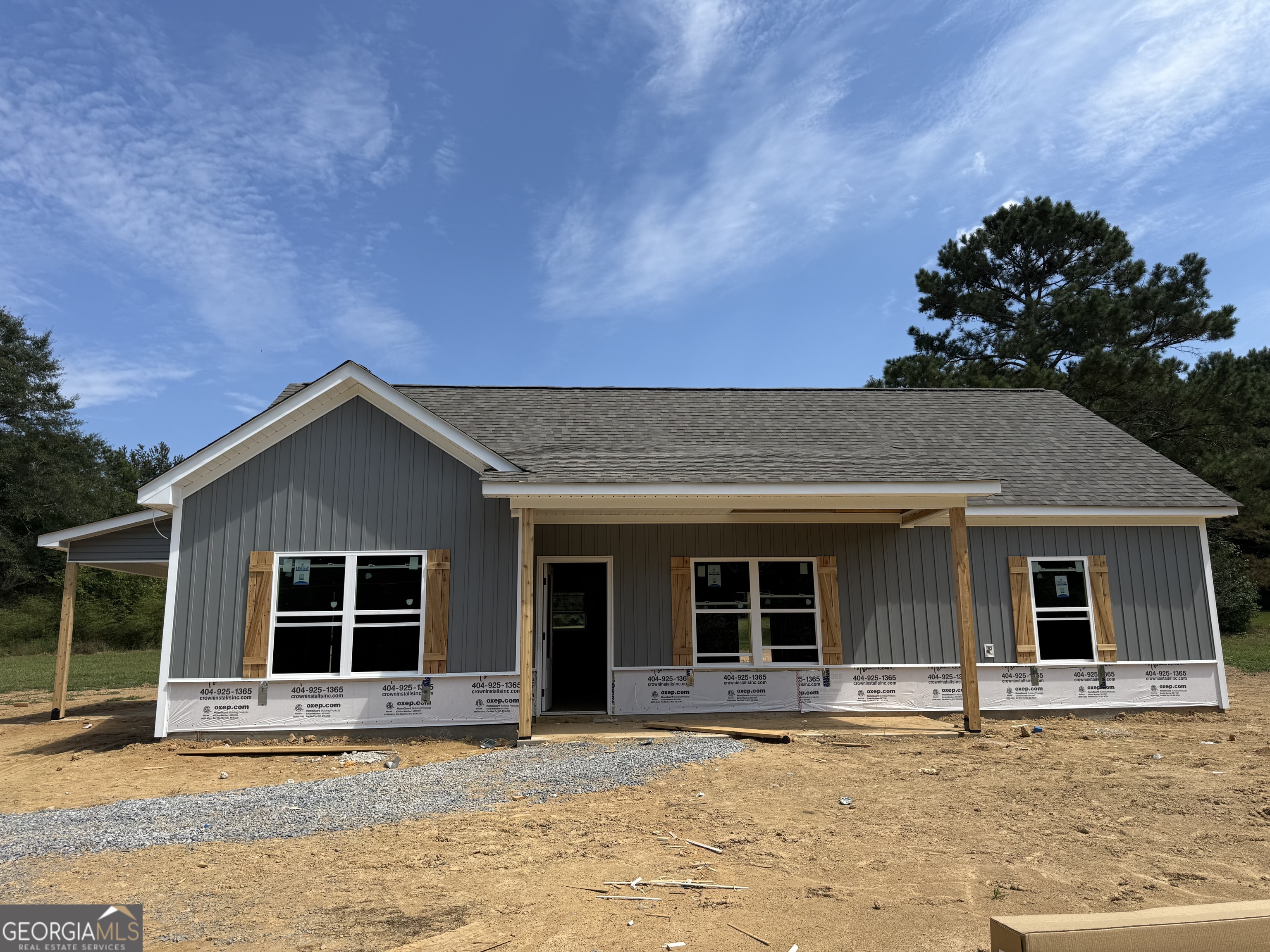 GORGEOUS NEW RANCH ON 3.832 PRIVATE ACRES - NO HOA, NO SUBDIVISION - JUST COUNTRY LIVING AT ITS BEST!!! Limited-time offer: Get a FREE appraisal and $3,000 in incentives when you work with our preferred lender! (Ask listing agent for terms.) Escape the hustle and bustle and come home to peace and privacy! This stepless ranch with attached carport is under construction on a picturesque 3.832-acre lot in the quiet countryside north of Buchanan, just off Hwy 27 heading toward Cedartown. Mostly cleared pastureland surrounds the home, and an old barn located behind the house adds extra character and charm. Step inside to soaring vaulted ceilings and an open-concept layout that feels light, bright, and welcoming. With 3 bedrooms and 2 full baths, there's plenty of room to spread out-and yes, there's still time to make it truly YOURS! Thoughtful selections throughout include modern gray tones, durable luxury vinyl plank flooring in main living areas, plush carpet in bedrooms, and stylish granite countertops. The kitchen is the heart of the home, featuring a counter-height bar and stainless steel appliance package (electric range, microwave, and dishwasher included!). The private owner's suite offers a large walk-in closet, double vanities with framed mirrors, granite countertops, and a beautifully tiled shower. Two secondary bedrooms share a stylish full bath with granite vanity and tub/shower combo. The family room is anchored by an electric shiplap fireplace, and ceiling fans add comfort in key spaces. Outside, the home will showcase Sterling Gray siding with stone accents, wood-stained details, and Weathered Gray shingles for timeless curb appeal. Don't miss this rare opportunity to build your dream home in the country-with room to breathe and no HOA restrictions! Photos are representative and may not reflect the actual home. ***Construction is underway-contact the listing agent today!***