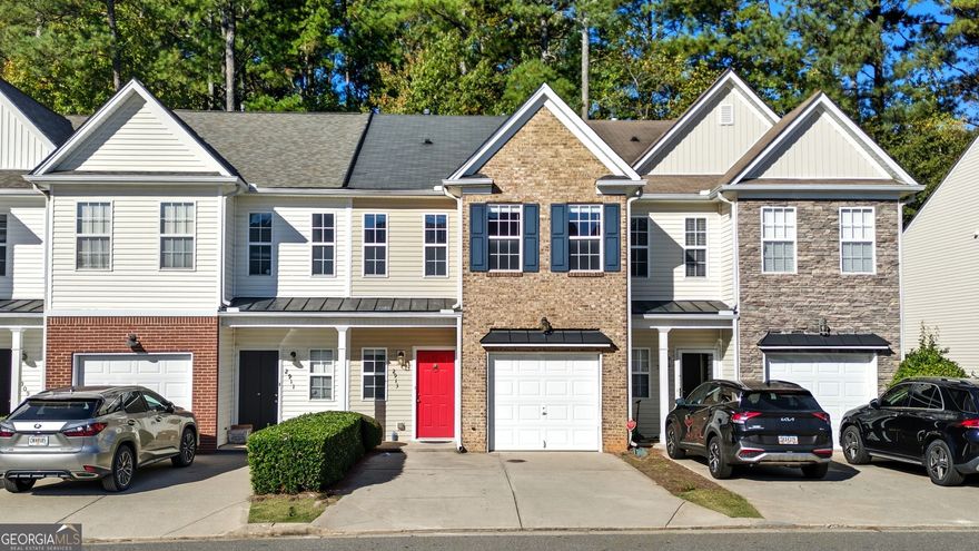 Perfectly positioned near Halcyon, The Collection at Forsyth, The Greenway, Fowler Park, golf courses, and quick access to top-rated schools, healthcare, grocery stores, shopping, dining, and year-round entertainment. All just minutes away! This cozy townhome offers convenience and low-maintenance living. A covered front porch and brick accent peak, complemented by a one-car garage and attached driveway for easy parking. Inside, the family room features a classic fireplace and mantel. Decorative column detailing leads into the eat-in kitchen with a pantry and open view to the family room, creating a comfortable, connected layout. Upstairs, you'll find two spacious vaulted primary suites, each with French doors leading to private en suite bathrooms perfect for roommates, guests, or a dual-owner setup. The laundry room is conveniently located upstairs near the bedrooms for everyday ease. Step outside to a private patio with a wooded backdrop and a wood fence partition offering extra privacy. Yard maintenance and trash service are included, giving you a truly low-maintenance lifestyle. Residents also enjoy a community walking trail that winds around a peaceful pond with a water feature and pergola seating area. The perfect spot to relax or take an evening stroll. Experience the ideal combination of comfort, convenience, and community in this thoughtfully designed Forsyth townhome!