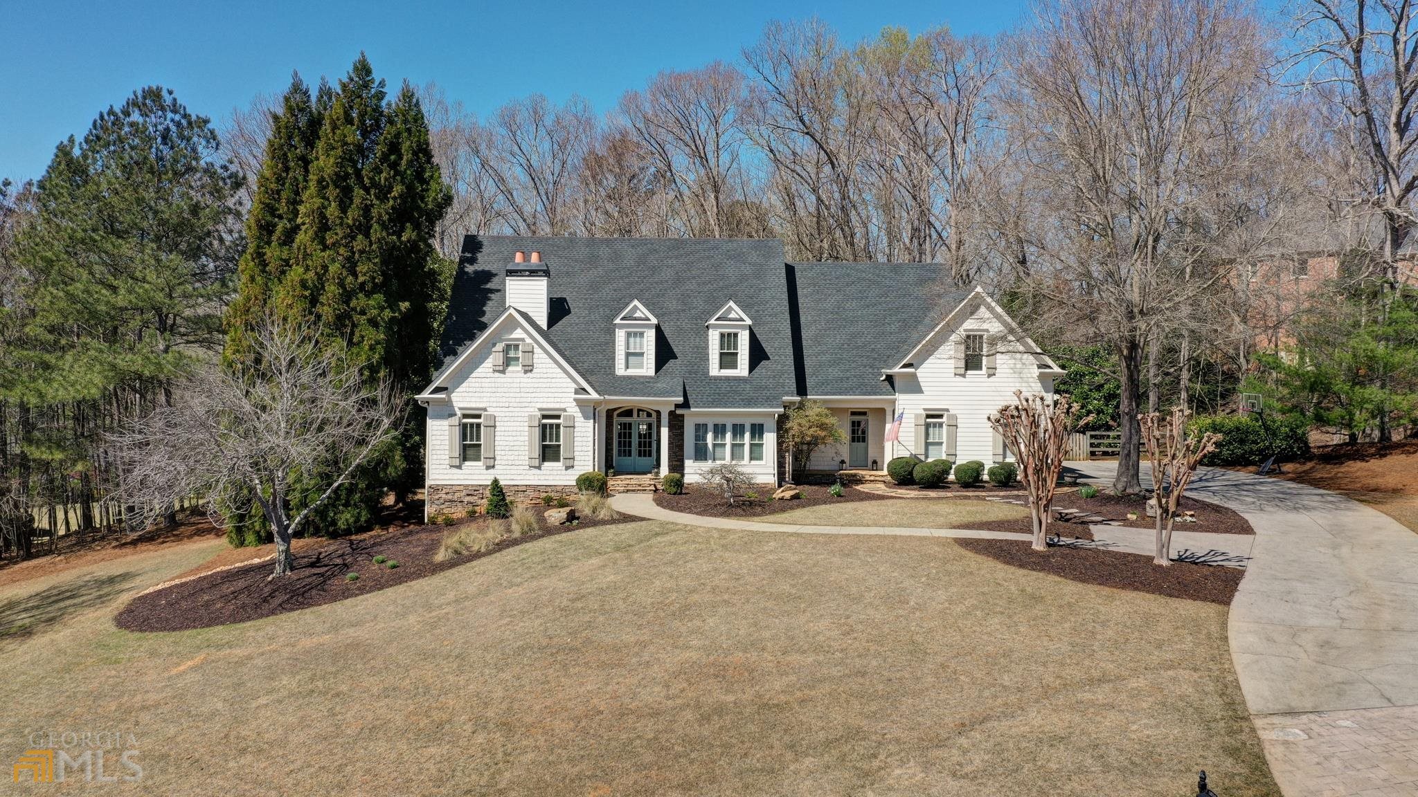 ***WELCOME HOME***This home is perfect with every designer detail imagined and LIKE NEW! Come enjoy this masterpiece in Milton! Immaculately maintained with every inch noted. Nestled on the Richmond Glen ridge, #1010 has ultimate privacy on a 1+ acre lot. The sprawling open floor plan features Southern front porches, an abundance of light, hardwood flooring, glorious views from every window, seven bedrooms, five baths and a full, daylight basement. Pale turquoise blue French doors open into the 2-story foyer with a lovely architecturally double turned staircase. Formal dining room and living room flank the entry with custom trim work throughout. Living room/home office/music room has a gas fireplace with upgraded tile surround & hearth & reclaimed wood beam mantle, can lights, custom wainscoting and morning/evening bar connection to the master suite. Center great room features a designer focal wall and French-door opening to the rear porch and private backyard. New fabulous renovated chef's kitchen has open concept plan with quartz counters and workstation, apron front sink, center island with bar seating, breakfast room, butler's pantry, walk-in pantry and fireside keeping room. Keeping room has a reclaimed barn wood mantle, ship-lapped walls and a new windmill fan. Large multi-purpose mudroom has built-ins and is conveniently located just off the garage for the family drop zone plus an additional separate front entry/exit. Master suite-on-main has a tray ceiling with reclaimed ceiling feature, windmill fan and a completely remodeled and gorgeous spa bath...too many specialty features to list, but some include floating double vanities, VICTORIA ALBERT soaking tub, reclaimed shelving, LED mirrors and closet systems! Four huge bedrooms with 3 baths, craft closets and vast storage complete the upper level. Full, daylight basement is partially finished with an open staircase, media room, full bath and two bedrooms. The additional unfinished area flaunts a workout room, game room, workshop, flat walk-out entry to backyard and a massive storage room! Side entry three-car garage. Nature preserve property has a completely private and fenced backyard and can easily be outfitted for a pool and/or any outdoor amenities your heart desires. Richmond Glen is a highly sought-after community that serves award-winning top schools. Swim, tennis, clubhouse, soccer field and play areas are all encompassed in this special gem just north on Birmingham Highway, past Milton High. Minutes to downtown Crabapple, Milton and Alpharetta, highways, shopping, Avalon, Halcyon, North Ga Wineries, hiking trails and so much more! ***UPGRADES: NEW HVAC, (2) NEW water heaters, whole house water filters, NEW paint, NEW carpet, tongue & groove porch ceilings, NEW light fixtures, NEW quartz kitchen counters and apron sink, NEWER stainless dishwasher and refrigerator, NEW kitchen can lighting all converted to LED + baffles, additional spray insulation in attic, reclaimed wood mantles and ceiling features, shiplap walls, curtain panels, windmill fans, LED lighted mirrors, closet systems, faucets, barn doors, custom trim features, specialty master bath renovation finishes with hidden venting, linear drainage and designer Victoria Albert resin materials! TOO MUCH TO SHARE! You'll have to come and see!