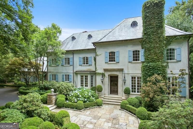 One of the most beautiful estates in Buckhead featuring a 5.01 acre gated and Authentic French Country Chateau. The estate was masterfully redesigned by Yon Pak and Dan Carithers with many of the redesign areas of the home featuring classic antique materials imported from Europe. "Maison des Bois" offers a mix of family living and entertaining spaces on a grand scale with  fireplaces, a theatre, 2 offices, nanny suite on the terrace level, craft room & an exercise room. The Great Room opens to a limestone terrace overlooking the formal flat rear lawn lined with cobblestone pathways which lead to the secluded Summer house and pool with spa. The Summer House features a full bath and a full Kitchen with Sub Zero, Refrigerator/Freezer, beverage drawers, Etc.  The Kitchen in the Main House features total top of the line quality appliances such as Sub Zero, Dacor, Viking, etc. Beautiful stone countertops with a fabulous large center island make this truly a Chef's Kitchen that anyone would love to enjoy or just show off. Meticulously maintained landscape throughout the property with multiple children's retreat spaces on the estate. There is a 3 car garage inside the interior gate with ample parking for several additional vehicles to the side of the home or on the paved turnaround drive at the front of the estate. The home also enjoys having an emergency generator which is always ready should there be any unforseen power outage. Multiple high capacity HVAC systems insure that the interior of the home will always be comfortable for everyone within the home. There is potential for subdividing property, possible equestrian estate or compound by adding additional homes. Or, perhaps adding a tennis court.