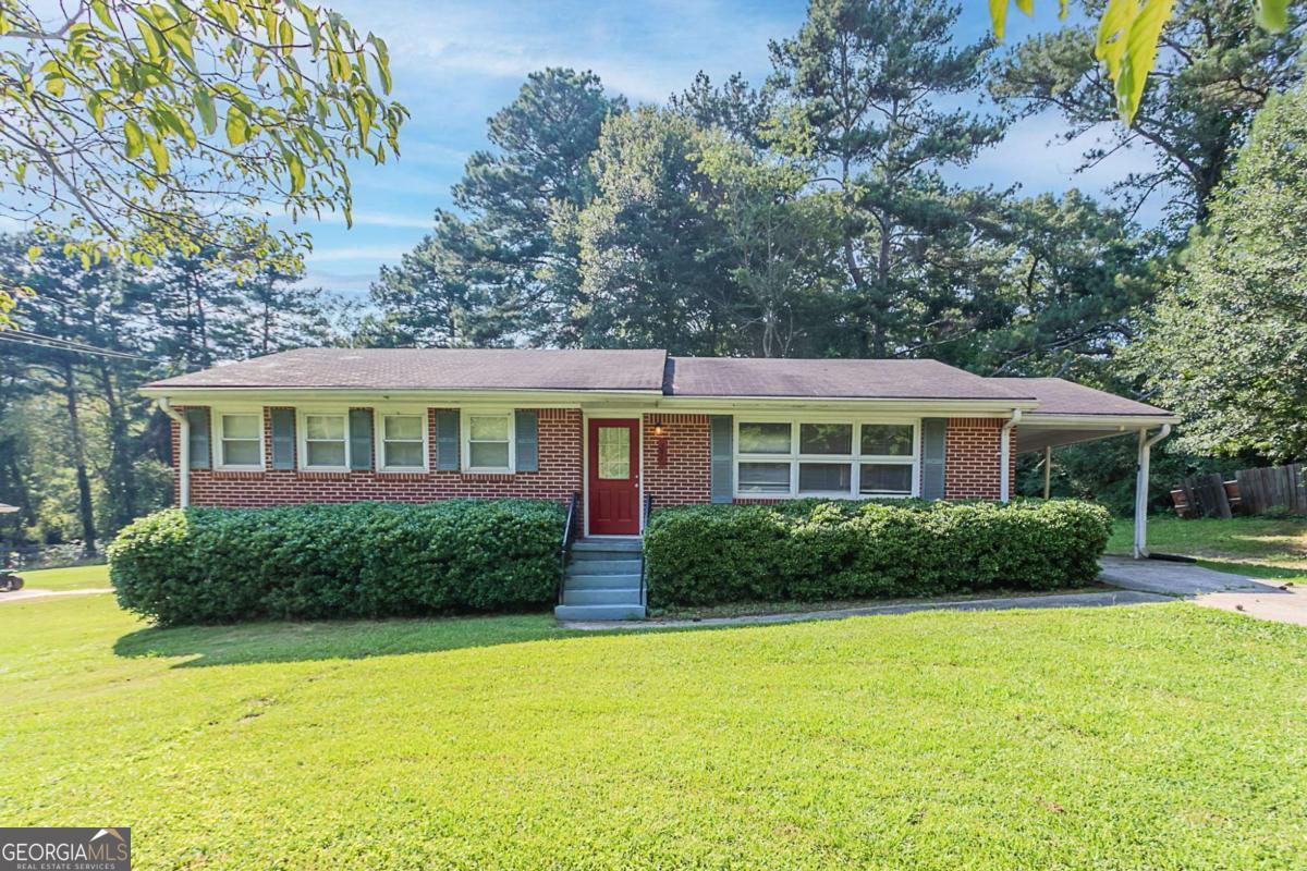Classic ranch in Stone Mountain featuring three bedrooms and two baths-all on a single level. The layout flows from the living area centered around a cozy fireplace into the adjacent dining and kitchen space, complete with modern finishes and a pantry. Oversized windows fill the home with light, while luxury vinyl plank flooring adds a warm, durable feel. Outdoors, enjoy a fenced backyard surrounded by mature trees, plus a patio ideal for gatherings. Located close to schools, parks, and MARTA, this home offers convenient low-maintenance living and appeal to both owner-occupants and investors.