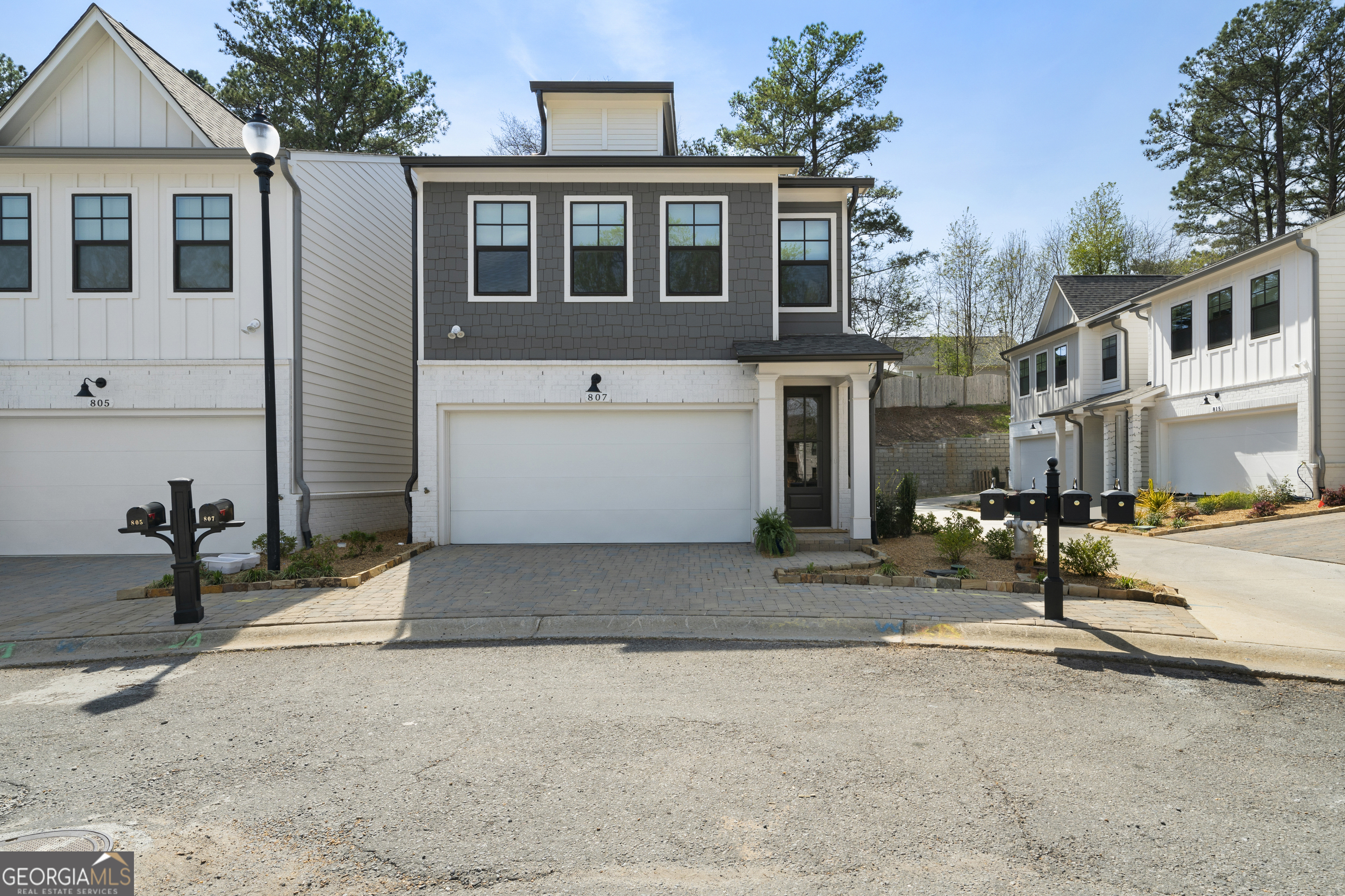 Welcome Home, to the much sought after Charolotte floorplan. You will find this "end unit" on a quiet cul-de-sac street inside the gated community that is about 1 mile to Downtown Woodstock. Truly the heart of every home is the kitchen and you will find it to be the center of the floor plan. The quartz countertops, expansive island along with the 6 burner range makes this a chef's dream kitchen! The family room highlights a warm and cozy electric fireplace flanked by a shiplap wall and beautiful wood mantle. The home features many upgrades throughout to include all black hardware and a finished garage floor. Woodstock has received many notable accolades recognizing the commitment to community development, innovation and quality of life! Hurry to enjoy the Spring and Summer activities that the city offers, including the free Summer Concert series!