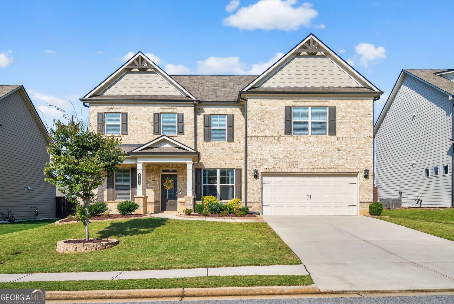 This gorgeous move in ready and like new home for sale in Flowery Branch welcomes you with warmth and character! Facing East, you'll enjoy the abundance of natural light flowing through this impeccable home. Step inside to an elegant entrance foyer with a formal living and dining room adjacent. The versatile living room is highlighted by a custom accent wall with detailed millwork and designer paint, making it a perfect space for a home office or study. A glamorous formal dining room with wainscotting is ready for your next dinner party. Hardwood floors flow effortlessly from the foyer into the kitchen and family room, where classic coffered ceilings and a warm fireplace set a welcoming tone. The family room opens to a chef's kitchen, featuring a large center island with granite countertops and chic white cabinets that complement the elegant millwork throughout. A guest bedroom and a full bath complete the convenient main level. Step outside to the oversized patio and a well-manicured, level, fenced backyard; an ideal spot for enjoying a cup of tea in the morning or watching the sunset in the evening. Upstairs, a spacious open loft provides the perfect space for a media room, workspace, or play area. Retreat to the very comfortable master suite, which boasts elegant trey ceilings and a luxurious spa-like bath with an oversized shower and built-in shelving. The roomy master closet offers plenty of space. Two additional bedrooms and a full bath complete the upper level. Located in Lancaster, a lively neighborhood with a community pool, this home offers easy access to shopping, dining, and I-985. You're also just minutes from popular area attractions, including the Mall of Georgia, Chateau Elan, and Lake Lanier Islands. Don't miss the chance to own this lovely home in a great location and neighborhood!