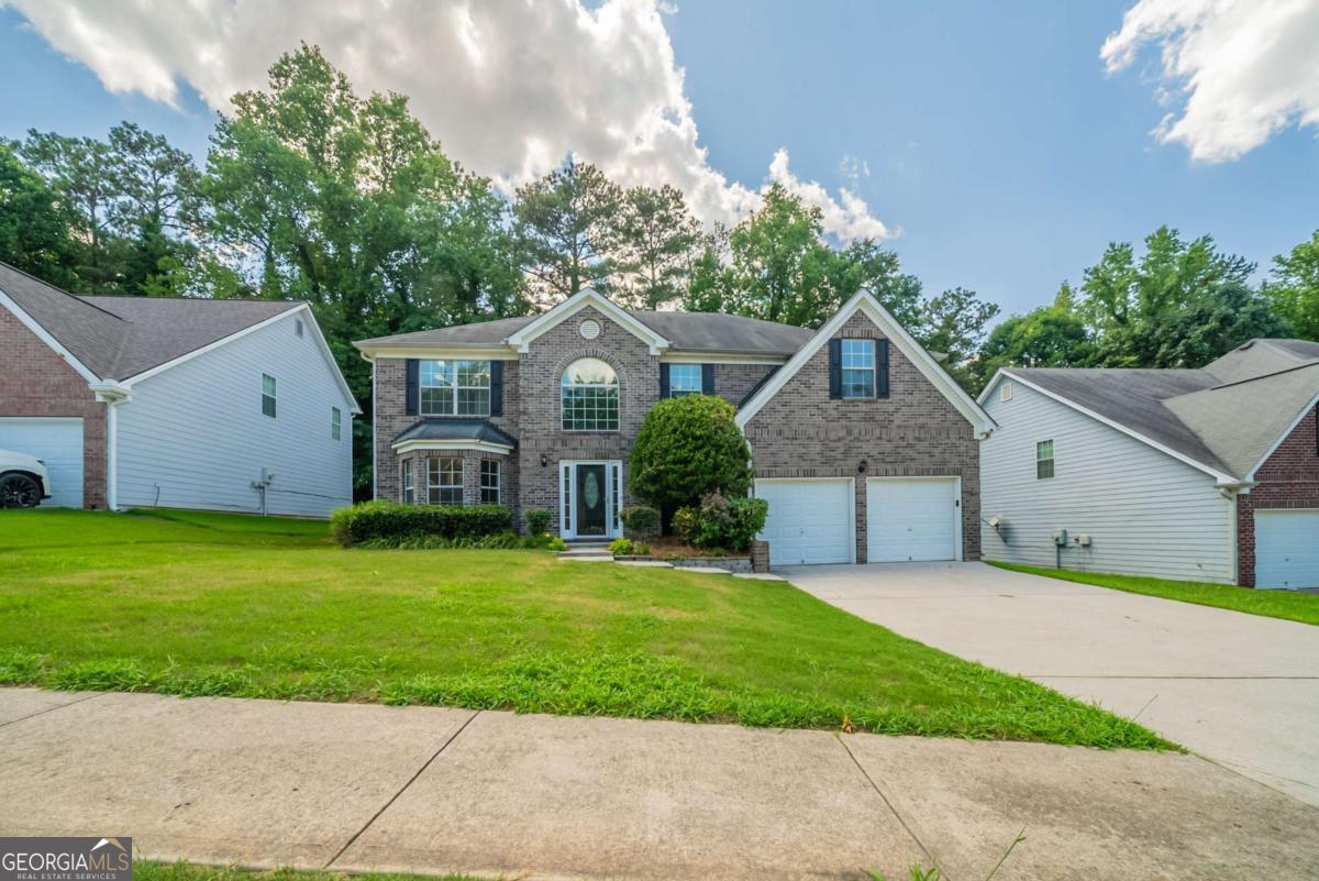 Spacious split-level home with inviting front porch and freshly updated interior. Enjoy brand new carpet and fresh paint throughout, creating a move-in ready feel. The vaulted family room features a cozy fireplace, perfect for relaxing or entertaining. The eat-in kitchen is equipped with solid surface countertops, stainless steel appliances, and ample cabinet space. The spacious primary suite offers a walk-in closet and a private ensuite bath with double vanity, separate shower, and whirlpool tub. Step outside to a back deck ideal for outdoor dining or relaxing. Additional highlights include a two-car garage and a well-designed floor plan that blends comfort and functionality.