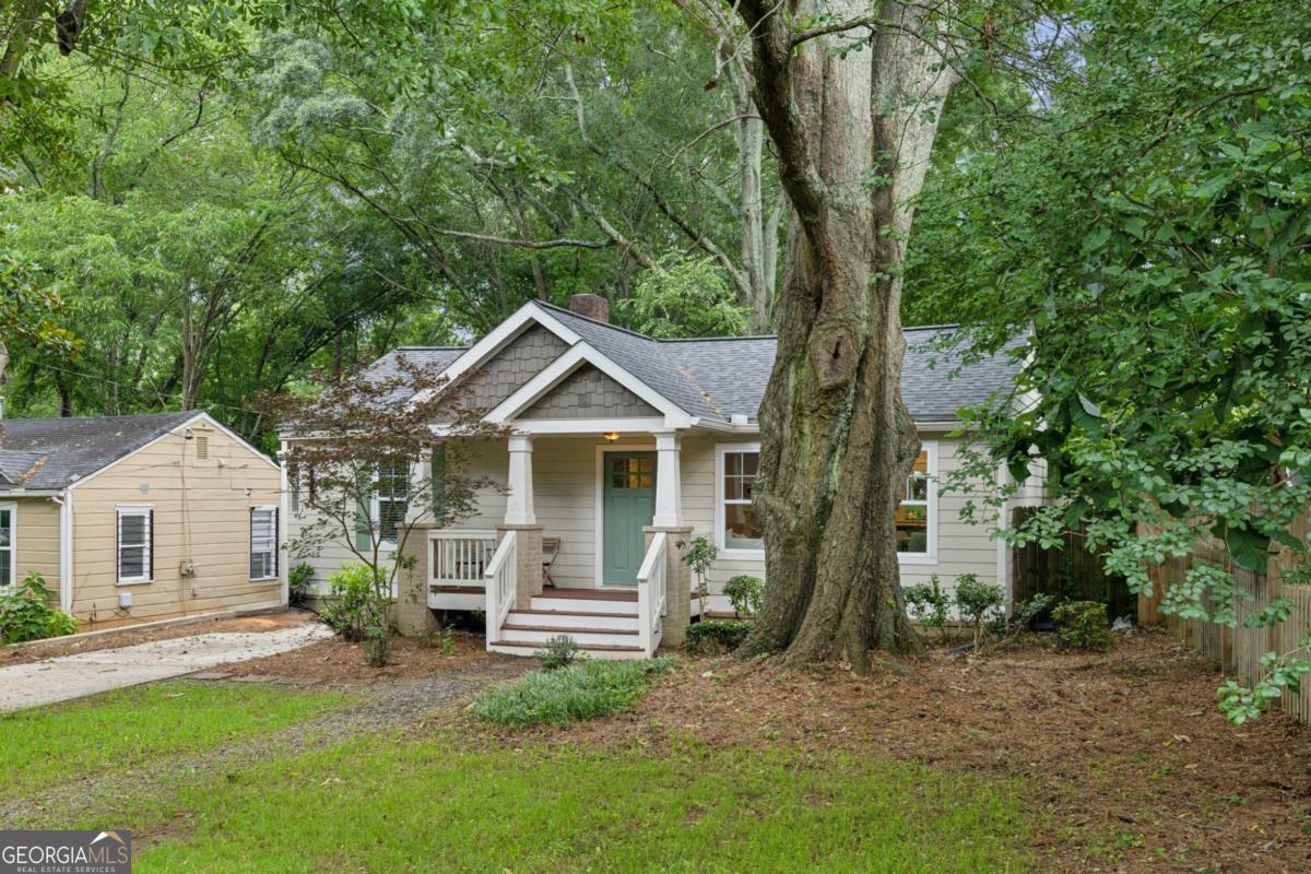 This charming 3-bedroom, 2-bath bungalow offers comfortable living with classic appeal. Step inside to discover hardwood floors that flow throughout the home, creating a warm and inviting atmosphere. The newer kitchen - central and open - is a true highlight. It features beautiful stained cabinetry and elegant stone countertops, perfect for both everyday meals and entertaining. With a split bedroom plan, you'll find privacy and convenience. The primary bath features double vanities and spacious walk-in shower with wall and ceiling sprays. The front two bedrooms share a convenient hall bath. Outside, a large, flat yard provides ample space for outdoor activities and relaxation. Additionally, a covered deck area provides shade on those hot sunny summer days! The home was completely renovated just over 10 years ago and has been lovingly maintained. Plus, a new roof was installed in 2024. Don't miss this opportunity to live in one of Atlanta's hottest neighborhoods- East Atlanta Village!