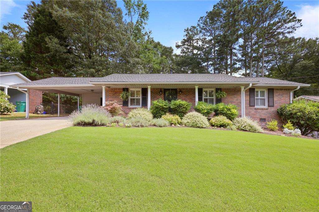 Welcome to 476 Concord Lane SE, a beautiful four-sided brick ranch in the heart of Smyrna. This meticulously maintained home offers 3 bedrooms and 3 full bathrooms, embodying both comfort and style. Step inside to discover beautiful hardwood floors and plantation shutters that grace the entire home, enhancing its charm and warmth. The extra-large family room, complete with a cozy fireplace, offers a perfect space for relaxation and gathering. The updated kitchen is a culinary delight, showcasing granite countertops, a new glass tile backsplash, and beautiful cabinetry and all of the bathrooms have been newly renovated. This home also offers a large flat backyard equipped with a fire pit, and a large deck, perfect for dining al fresco or enjoying a cup of morning coffee overlooking your peaceful fenced in oasis. The outdoor shed/workshop has been upgraded with new LVP flooring and electricity for your weekend DIY projects or a great place for storage. This home also offers you peace of mind with a brand new roof! Located just minutes from the vibrant Smyrna Market Village, I-75, I-285, the Cumberland area, and SunTrust Park, this home offers unparalleled convenience to shopping, dining, and entertainment options in addition. This lovely home also feeds into the highly sought after King Springs Elementary School. Don't miss this opportunity to own a beautiful home in a prime location.