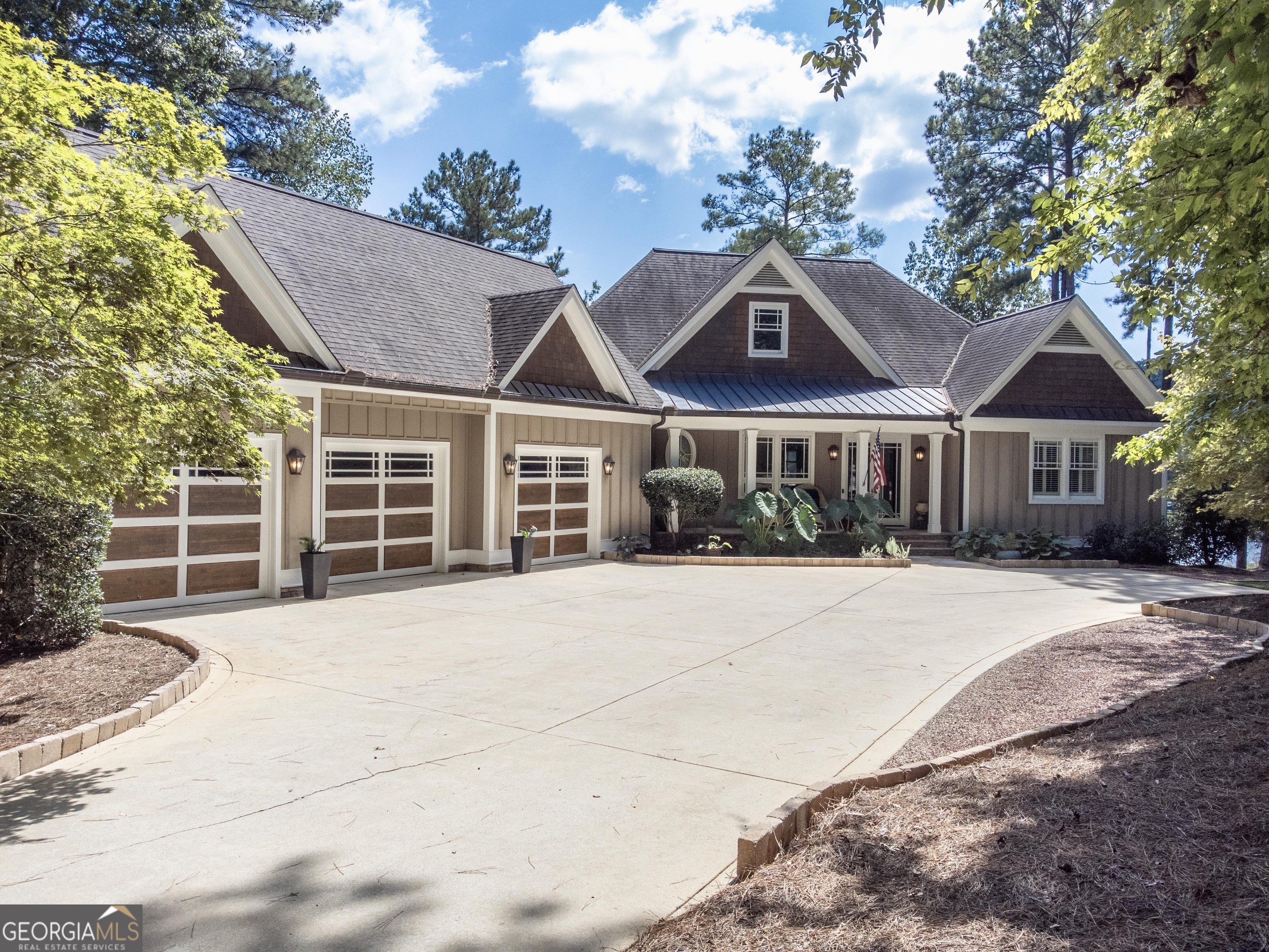 Spectacular Lakefront Oasis On A Point Lot with Unrivaled Views, Minutes from The Ritz and Richland Point at Reynolds Lake Oconee! Welcome to your dream lake house nestled on Parrotts Pointe, one of the best areas at Reynolds Lake Oconee minutes from the amenities and offering over an acre of privacy with an astounding 300+ feet of big open water frontage on flat expansive backyard. This extraordinary property is a rare gem, and boasts over 6,000 square ft with one-of-a-kind point lake property-a true haven for those seeking lakeside serenity. This stunning lake house is designed with entertainment in mind, boasting ample lakeside spaces to savor every moment by the water. Whether you're hosting gatherings, picnicking with the family, fishing, engaging in a friendly game of cornhole, or exploring the lake on kayaks and paddleboards, this backyard has it all. Location is paramount, and this residence enjoys an exceptional one. Just minutes away, you'll find the prestigious Ritz-Carlton Lake Club and Richland Pointe. This spacious abode offers plenty of room for family and friends with 5 bedrooms and 5.5 baths, gourmet kitchen with upgraded appliances, four-seasons porch overlooking lake, stunning great room with fireplace and beams, gorgeous dining room with lake views, oversized primary suite with sitting area and spacious bathroom with built-in desk, laundry room, pantry and mudroom with lots of storage, a full apartment with kitchen above the three-car garage. The terrace level features a family room, billiard/game room, full bar, media room, two additional suites and a workshop with lots of storage. Step out into one of the best lake backyards, sprawling with impressive landscape and 300+ water frontage, offering plenty of room for a future pool. Marvel at the incredible view from your private dock or hop into your boat to enjoy a sunset cruise. Retreat to the expansive lower level lakefront screened porch with fireplace to enjoy a glass of wine while taking in the beautiful nature. Chat fireside with family and friends at the end of a gorgeous day. Don't miss the chance to own this remarkable lakefront retreat that seamlessly combines luxury, leisure, and an unbeatable location. This is more than a house; it's an invitation to embrace the lake lifestyle you've always dreamed of. Membership is available.