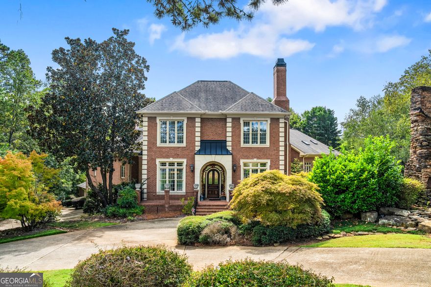 Welcome to this meticulously maintained full-brick estate, gracefully situated on 1.25 private acres in the highly desirable East Cobb area.With 5 bedrooms, 8 baths, and approximately 8,637 square feet of refined living space, this residence offers a rare blend of luxury, comfort, and gracious design. From the moment you arrive via the circular drive, you'll be greeted by lush landscaping, ambient outdoor lighting, a serene pond, and a historic 150-year-old chimney that gives character to the front facade. The property includes a five-car finished garage (one bay is used as a workshop with front and rear access), plus lower lot space capable of accommodating up to 20 vehicles-perfect for entertaining or hosting gatherings. Grand, 11- foot ceilings in the foyer lead you into a world of architectural elegance. The family room boasts soaring 21-foot ceilings and an ornate fireplace, while the formal living and dining rooms feature complementary tray ceilings and a second fireplace. A paneled study offers quiet retreat, and a nearby space to serve as a secondary office or sitting room adjacent to the primary suite. Designed with both function and style in mind, the kitchen is outfitted with double ovens, a 5-burner gas cooktop with downdraft vent, Sub-Zero refrigerator, dual dishwashers, warming drawers, trash compactor, expansive pantry, and even a dumbwaiter for ease from garage to kitchen. The adjoining keeping room and breakfast area (with its own fireplace) complete this heart-of-home space. Two master suites grace the main level. The primary suite features dual closets, a spa-style en suite with jetted tub and large shower, private screened porch, a sitting room, and it's own laundry! The second primary includes a generous walk-in closet and en suite bath. Upstairs awaits a generous open loft with built-ins, two additional bedrooms, and two full baths. The daylight basement is an entertainer's dream-complete with spacious living/entertainment rooms, a bar/kitchenette, exercise area, pool table space, an additional bedroom with sitting area, and two full baths. High ceilings, a double-sided fireplace, and dual staircases (front and rear access) enhance the flow.  Outdoor Living & Amenities The outdoor spaces are thoughtfully designed for both entertaining and relaxation. Retractable screens and awnings extend living space seamlessly from indoor to outdoor. A large deck with Ipe flooring, terrace-level screened porch, multiple stairs to lower levels, and ambient lighting create an inviting outdoor environment. The grounds are supported by an irrigation system fed by a well, and additional features include a full-house central vacuum, dual 50-gallon water heaters with circulation, a security system, controlled lighting, attic access via retractable stairs, and ceiling fans in all key rooms. This remarkable estate offers the perfect balance of sophistication, comfort, and functionality. Schedule your private tour today and experience this extraordinary property for yourself. Offered by Trailside Equities, an experienced builder and home construction company, this home provides buyers with the chance to create a residence that truly reflects their personal style and preferences at a great price.  The property is available for purchase now, and following closing, our team will work with you to renovate and customize the home to your specifications if it is not perfect for you as-is.  Whatever you envision for this luxury property, Trailside Equities has the expertise to bring your vision to life.