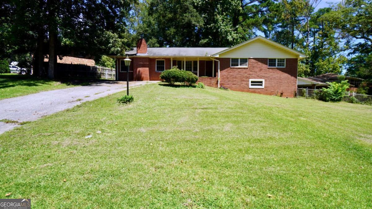 Welcome to this beautifully updated all-brick ranch in the heart of Morrow! This 4-bedroom, 2.5-bath home offers nearly 2,800 square feet of living space and has undergone several improvements to enhance its comfort and appeal. The main level features hardwood floors, an inviting living room with a cozy fireplace, and a spacious kitchen with granite countertops, stainless steel appliances, and a breakfast area. The primary suite includes a walk-in closet and private bath, while the finished daylight basement with interior and exterior access provides versatile space for a family room, office, or guest suite. Outside, enjoy a fenced backyard, covered porch, and ample parking with no HOA restrictions. Conveniently located just 20 minutes from Hartsfield-Jackson Airport and minutes from I-75, shopping, parks, and Clayton State University, this property is perfect for a homeowner or as a great investment opportunity with strong rental potential.