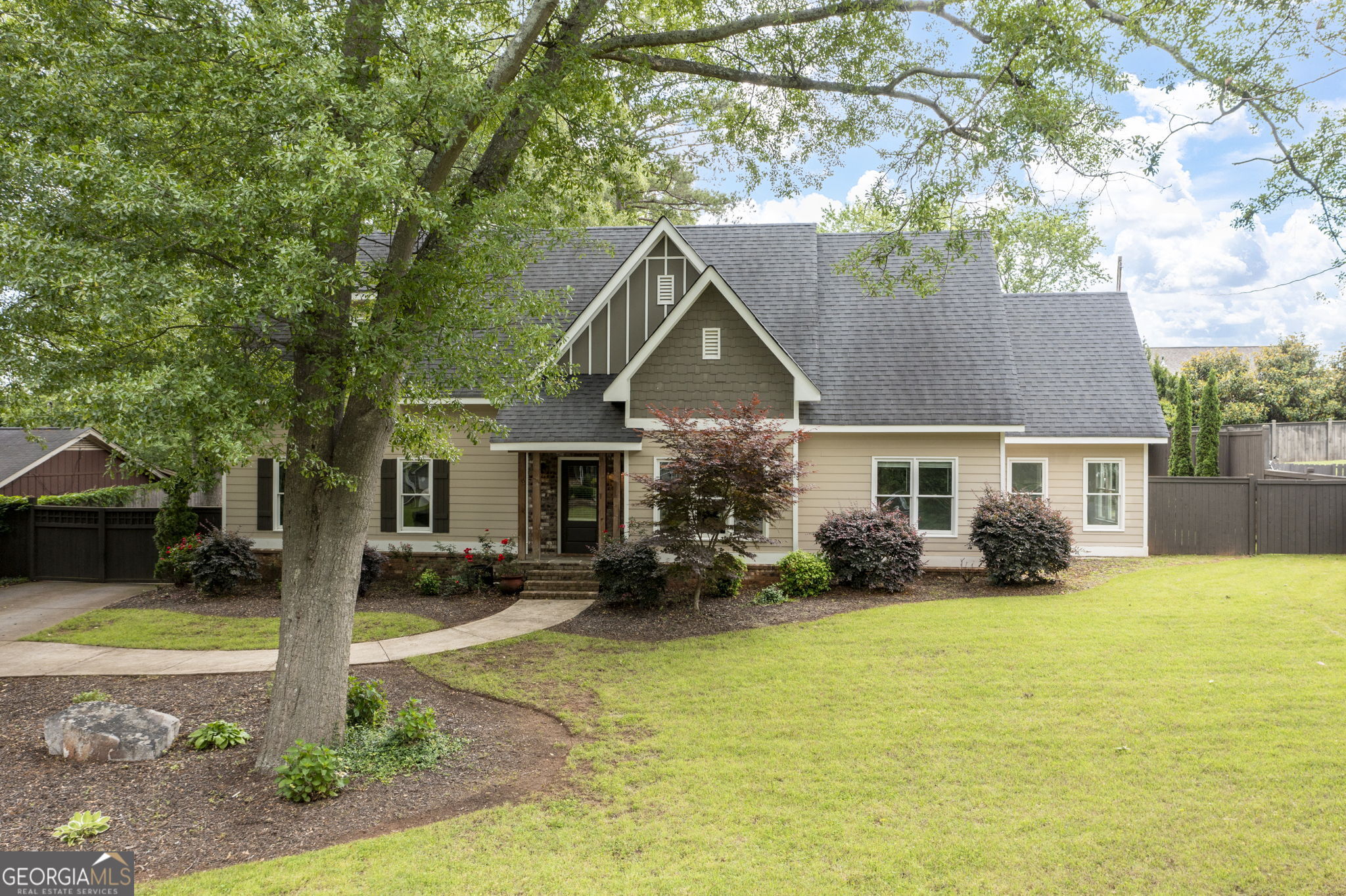 Must see this unique craftsman style home customized with quality trim, exposed beams, shiplap wall, trey ceilings, recessed lighting - upgrades throughout. Six bedrooms and four full baths! Gourmet island kitchen features large island with quartz countertops, ss appliances, oversized refrigerator & freezer, brick backsplash, double oven, gas stove, pot filler faucet, custom walk-in pantry, abundant white cabinetry, coffee bar, wine fridge, ice machine, and breakfast bar, Master suite includes hardwood floor, trey ceiling, recessed lighting, barn door to lavish bath with double vanity, tile floor, garden tub, huge tile shower with dual multi-head shower sprayers, huge walk-in closet and a multi-purpose room off the master bath. Separate dining room w/wainscoting. Entry foyer w/tongue and groove ceiling. Family room with fireplace. Hardwood floors throughout with the exception of some bedrooms. Quality finishes in all baths. Laundry room with built-ins, (washer & dryer to remain). Detached 2-car garage. Tankless hot water heater. Large patio and veranda! Home has a privacy electronic gate on the driveway. Convenient location, closing to shopping, dining, and I-75.
