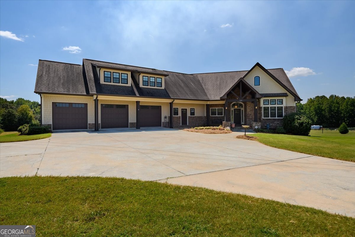 A Rare Find - First Time on the Market! This gorgeous home sits on 10 acres of picturesque, pastured land, ideal for a mini farm, horses, or anyone seeking the peace of country living with plenty of usable space. Inside, the open-concept design features a bright living area with soaring beamed ceilings and a spacious custom kitchen complete with a large island - perfect for entertaining and gathering with loved ones. A cozy sunroom opens directly off the living room and leads to the outdoor deck. The primary suite is a true retreat with private deck access, an extra-large tile bathroom, includes a walk-in shower with built-in bench, custom cabinetry, and a spacious walk-in closet. A second bedroom on the main level, includes a full bath, provides main-level flexibility. Upstairs, you will find a massive private living space completely stubbed and ready for a second kitchen making it ideal for a teen retreat, guest suite, or in-law suite. This level includes a bedroom with walk in closet, a full bath, and a versatile living space with convenient access to the walk-in attic. The full unfinished basement offers endless potential, featuring a full-size garage door and two additional entry points. Additional highlights include a central vacuum system, a generous laundry room with built in cabinets, sink and countertop, a 3-car oversized garage with extra storage and direct access to the backyard, plus a Generac generator and underground propane tank. The land features a creek and plenty of open space that can be fully fenced for animals or recreation. Words and pictures can't fully capture this property - it must be seen to be appreciated! Appraisal in documents.