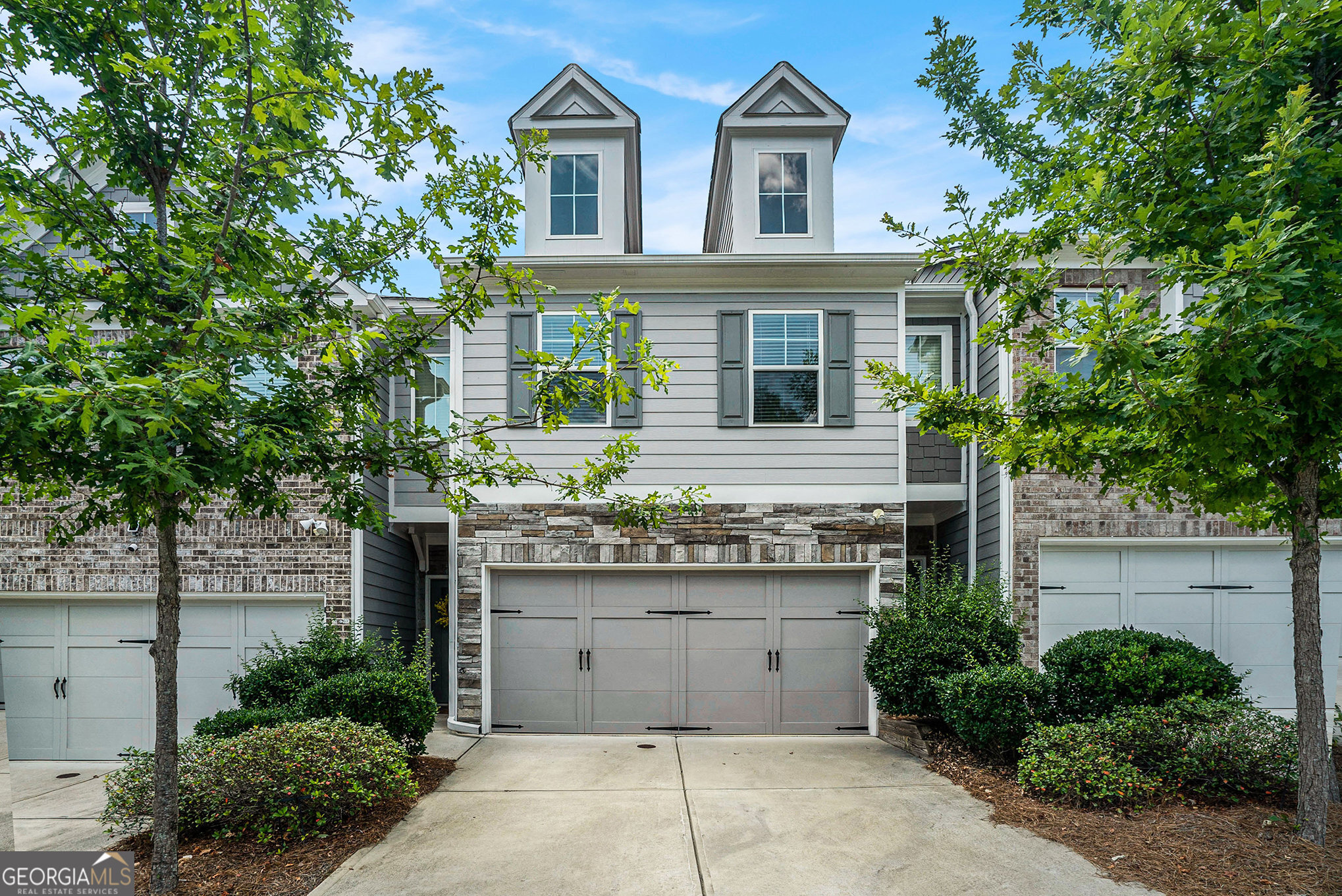 Step into this beautiful modern townhome that blends style, space, and privacy in one of Conyers' most convenient locations. From the moment you walk in, you'll notice the charming modern finishes and thoughtful layout that make this home truly move-in ready. The open concept living area with a cozy fireplace is perfect for both quiet nights in and entertaining guests. The modern kitchen offers efficient functionality while keeping everything close at hand, offering an open atmosphere that is perfect for entertaining. A guest bathroom on the main level provides ease and comfort for your guests. Upstairs, two more spacious bedrooms await, including a comfortable owner's suite with room to relax and recharge. Out back, enjoy the private, fenced-in yard shaded by mature trees. It's a peaceful retreat you don't often find in townhome communities. Located in a well-maintained neighborhood just minutes from I-20, this home offers easy access to everything Conyers has to offer, including historic Olde Town, parks, shopping, and dining. With an attached garage, updated interior, and welcoming community feel, this home offers comfort, convenience, and a place you're proud to call your own. Why settle for ordinary when you can make this home yours, schedule your private showing today!