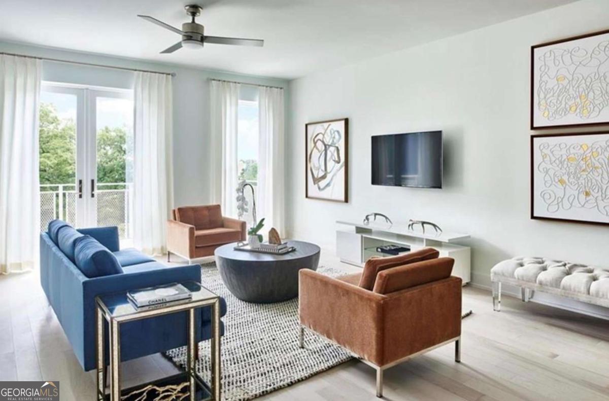 Come experience this natural light-filled 1 bedroom condo on the top floor of The J5 Midtown midrise condo building. Unobstructed views from this condo unit overlook the J5's pool and Midtown's historic Garden District. Features include wide plank hardwood floors throughout, a large kitchen island with white quartz countertops, & Kitchenaid stainless steel appliances, and 2 custom California Closets included with this unit. Bring the outside in with floor-to-ceiling windows & a private outdoor terrace. Take a break from working from home by taking work outside to the private landscaped garden promenade area with plenty of places to log in and keep productive. In the evenings, gather on the lawn in the outdoor entertainment area with a summer kitchen, fire pit, al fresco dining & three distinct social zones. Vacations not required, when just an elevator ride away is the relaxing resort-style wet deck, saltwater pool & plenty of lounge seating areas. Indoor perks include an attended hotel-style lobby with 24-hour concierge, security, pet spa, state-of-the-art fitness center, multiple social gathering spaces, and a sunset rooftop lounge overlooking Midtown Atlanta. Washer/Dryer, Refrigerator and all kitchen appliances shall remain with the property at time of sale.