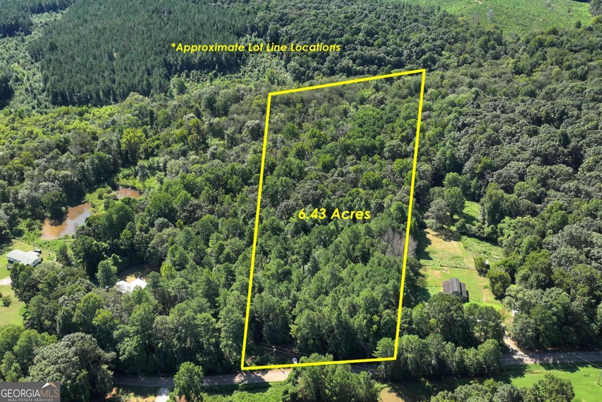 6.43 Acres - Prime Location Near I-85 & Banks Crossing Discover the perfect setting to build your dream home on this 6.43-acre property. Conveniently located just minutes from I-85 and Banks Crossing, you'll enjoy quick access to shopping, dining, and everyday conveniences while still having the privacy and space you desire. A peaceful creek runs through the property, adding natural beauty and a serene backdrop to your future home. With ample room for your custom home, outdoor living, or even a hobby farm, this property offers endless possibilities.