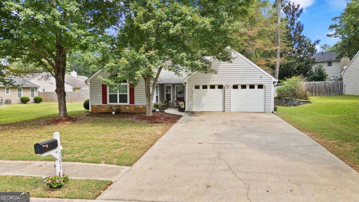 Welcome to 3255 Caley Mill Drive, a beautifully renovated stepless ranch in the heart of West Cobb - perfect for first-time homebuyers, empty nesters looking to right-size, or investors seeking a low-maintenance property with minimal HOA fees. This meticulously maintained home combines comfort, style, and convenience, offering a move-in-ready retreat with thoughtful updates throughout. Step inside to an open and airy floor plan with vaulted ceilings and abundant natural light streaming through newly installed, insulated vinyl windows. The inviting family room is the heart of the home, showcasing a floor-to-ceiling ledger stone fireplace with a reclaimed wood mantel and quartz hearth for a stunning focal point, creating the ideal centerpiece for cozy nights at home. Durable luxury plank flooring flows seamlessly throughout the main living areas and the primary suite, creating a cohesive and modern feel. The kitchen has been completely updated with granite countertops, glass tile backsplash, and stainless steel appliances - making both everyday meals and entertaining a delight. The primary suite is bathed in morning light from a large palladium window and features an en-suite bath with a walk-in shower accented by marble link tile and a mosaic stone floor. Two additional bedrooms and a full bath round out the inviting interior. Practical updates provide peace of mind and enhanced energy efficiency, including an HVAC system and water heater that have been replaced within the last 5 years. Outside, the large, level fenced backyard provides a private wooded backdrop with mature trees, ideal for gatherings, pets, or play, and is complemented by an expansive brick-trimmed patio perfect for grilling and relaxing. Nestled in a quaint and quiet community with a swimming pool, enjoy having nearby access to the Silver Comet Trail, The Avenues of West Cobb, Seven Springs Water Park, Mud Creek Soccer Complex, and countless options for shopping, dining, and entertainment. Commuting is simple with close proximity to the East-West Connector, Barrett Parkway, and local interstates, plus schools nearby. With all furniture negotiable, you can truly make this home your own with ease. Enjoy the perfect blend of modern upgrades, quiet surroundings, low HOA fees, and easy access to everything West Cobb has to offer - delivering exceptional value and everyday ease.