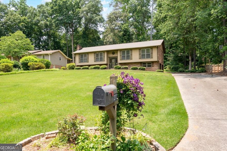 Blending vintage character with tasteful updates, this mid century style home is located in a quiet, established neighborhood where homes are rarely available for sale. Whether you are a retro enthusiast, savvy investor or creative remodeler, this home offers endless potential and unique features that are just not found in newer builds. If you appreciate the quality of 4 sided brick with cedar siding, a brand new 30 year architectural roof, vintage tile, and solid wood doors and cabinets, this is the one for you! The oversized living room has a brick fireplace, original wood paneling and a vaulted ceiling; the kitchen features stained wood cabinets and stainless steel appliances, and opens directly into a sunroom addition that the previous owners used in all 4 seasons. Just imagine enjoying the backyard gardens from the comfort of the deck or sunroom, and watching the birds at the feeder with your morning coffee! The primary bedroom is large with an attached en suite bath and walk in closet. Two secondary bedrooms, a hall bath and a dining room finish off the first floor. Downstairs is a finished flex room with a second fireplace that could be a movie room, 4th bedroom, playroom, teen hangout  or home gym. The oversize garage offers plenty of storage as it runs the full length of the back of the house. The yard is professionally landscaped and planted with many perennials that will return year after year to surprise and delight. The street ends in a cul de sac just one house away. No HOA! Minutes from Dallas Highway and the Avenues of West Cobb, and close to hiking trails, restaurants, the East West Connector and Marietta Square. Per seller request, no blind offers please.
