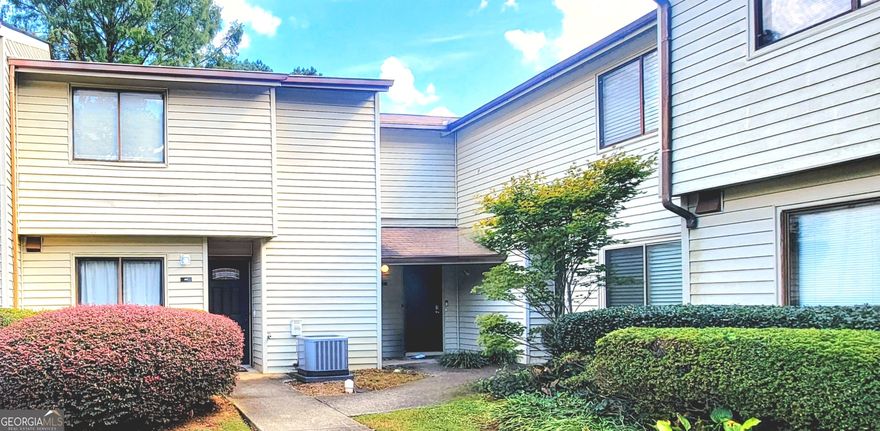 Beautiful 2 bedrooms, 2 and a half bath townhouse, plenty of natural light. !!! This is an end unit with tons of privacy!!!.  Waterproof plank vinyl on the first floor. New roof. The double patio doors in the kitchen and in the living room offer a serene view.  The living room boasts a beautiful chimney and two barn doors, creating a stylish space. The kitchen has real wood cabinets and granite countertops.  *** Dimmable LED light fixtures in the entrance, living, and kitchen***. The patio features a lovely design for plant enthusiasts and is perfect for barbecues and gatherings. There is also a half bath on the first floor and a closet in the patio.  Wood flooring on the whole second floor. Two master bedrooms, each with its master bathroom located at opposite sides, offer total privacy. The laundry is located in the hall. Close to Stores, supermarkets, restaurants, banks, 2 Walmarts, Costco, 2 Home Depots, and highway 85.