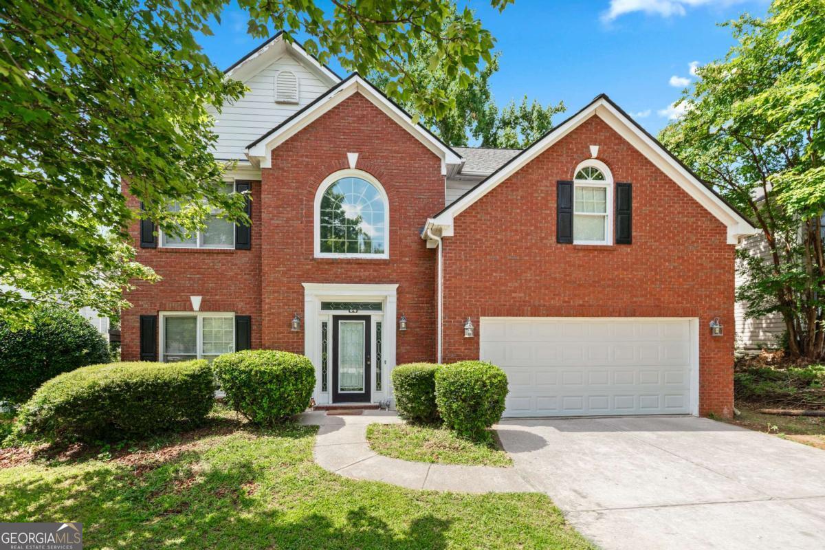 Attractive home in a highly sought after neighborhood of Lawrenceville with a low HOA and roof replaced in 2021! Welcome to this traditional brick front property featuring 4 bedrooms and 2.5 baths. Enter into the two story foyer where you will be greeted with updated flooring, bright, neutral paint colors, and loads of natural light. Just off the entry is the formal dining room with arched windows viewing into the family room which offers separate space to entertain or for a wonderful home office or study. Continue on into the family room where you will find built in shelving, a cozy fireplace, and warm toned hardwood floors. In the kitchen you will enjoy a sizable island, white cabinetry, stainless steel appliances, and a casual dining area. Also located on the main floor are the laundry room and a half bath. Head upstairs to find your oversized master bedroom with a modern trey ceiling, walk in closet, and en-suite bathroom which features double sinks, a vanity space, sleek white cabinets, a large soaking tub, and separate shower. The other three bedrooms are all spacious, feature walk in closets and share the second full bathroom with double sinks and shower/tub combo. Enjoy an easy to maintain outdoor lot with simple landscaping and fenced backyard. Enjoy the outdoors from the back patio where you can unwind or entertain! Located in a highly sought after area near local shopping and restaurants making it the ideal residence. This property currently has a tenant family who is interested in staying in the home if looking to keep this charming property as a rental opportunity.