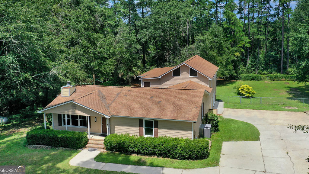 Enjoy the best of Statesboro living in this home designed for gathering and flexibility. With 3 bedrooms and 2 baths on the main level, a downstairs media room currently serving as a primary suite, and a spacious upstairs studio plus office, there's room for everyone-ideal for multi-generational living. The inviting living room with a brick fireplace and the open kitchen set the stage for family dinners, cozy nights, and everyday comfort. Step outside to your own backyard retreat featuring a sparkling in-ground pool, patio, and fenced yard-perfect for entertaining, summer fun, and peaceful evenings. All on 1.43 acres, offering privacy, space, and endless possibilities to make this home truly yours.