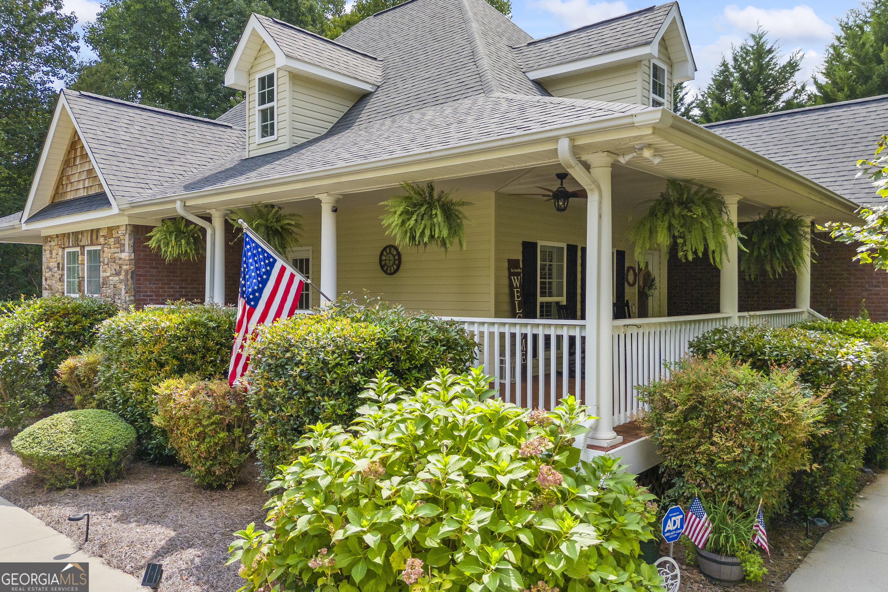 This is it, the home you have been waiting for! Impeccably maintained, this beauty has tons of interior space and multiple outdoor porches to enjoy the summer weather. Open kitchen, breakfast and dining area that leads to the living room, all with real hardwood floors and a cozy fireplace. Huge master suite with tile bath featuring walk-in closet, linen cupboard, jetted soaking tub and separate shower. On the other side of the first level you will find two additional bedrooms and a shared bath that can be closed off by a pocket door for additional privacy. A large two car garage that leads to a mudroom and laundry room is sure to please! Upstairs is a large bonus room that is perfect for that home office or hobby room. On the terrace level you will find a finished family/media room, bedroom, additional room with a closet and a huge partially finished bonus area with a pool table that comes with the house! This level is already stubbed for an additional bathroom and double doors leading to the exterior side yard. Enjoy the professionally landscaped yard and the wraparound front porch. There is an additional side porch off of the kitchen that is the perfect grilling spot. All of this on a quiet street, close to Hwy 365 for an easy commute in any direction! Don't delay, make your appointment to tour this special home today!