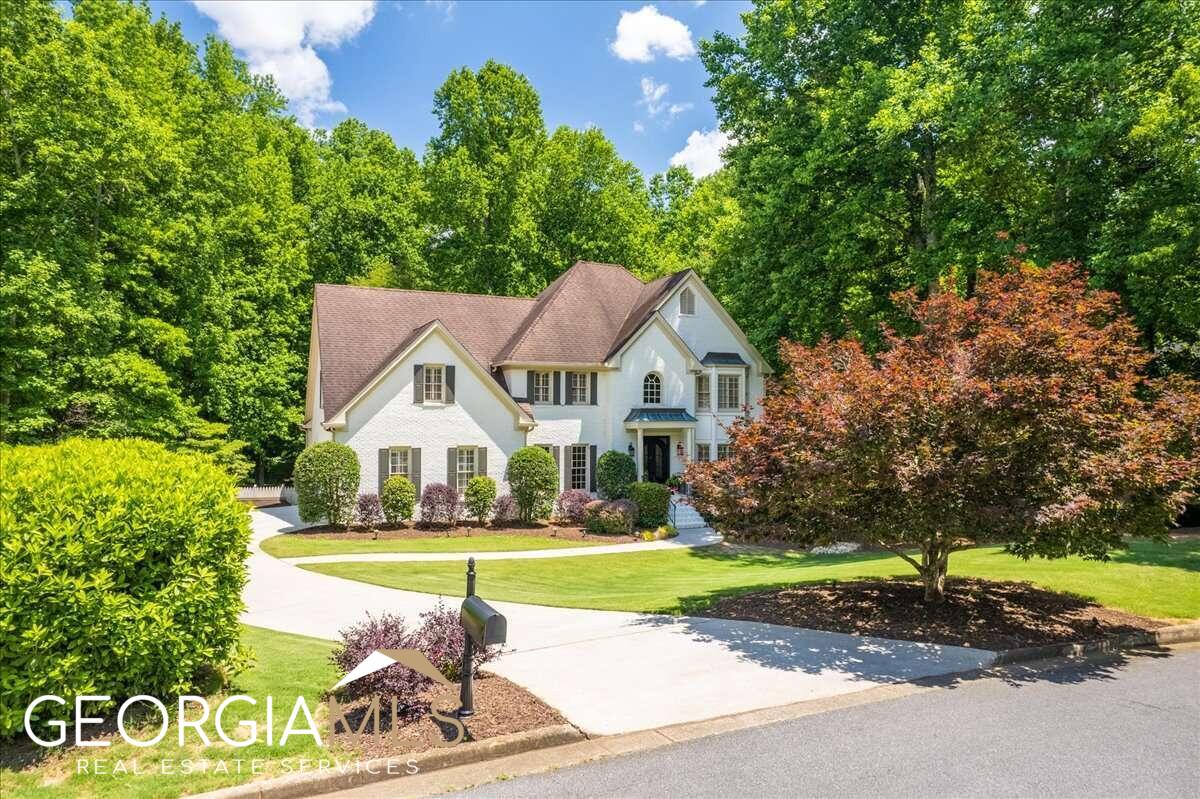 STUNNING painted brick home on OVER an acre PRIVATE flat lot. Updates throughout, including a gorgeous terrace level featuring a media/theater center, a billiard/recreation room, custom bar/kitchenette including refrigerator, ice maker & sink. Also featured on terrace level is a full bath & an additional room currently being used as an office. The terrace level opens out to an expanded patio with waterproof ceiling complete with built in heaters, a spacious fire pit and a natural fire pit in rear of back yard, The main level features a great flow for entertaining with an adjoining living room and dining room, as well as a huge, vaulted fire-side family room. Separate, sun-filled sunroom. The renovated kitchen is the heart of this home with a walk-in-pantry, warming drawer and island with gas cook-top. The curved deck off of the sunroom overlooks a lovely manicured, level backyard, with a wooded area at the back for shade and privacy. Upstairs, the primary bedroom has a deep tray ceiling and bath features his/her vanities, slate/tile flooring and a custom designed walk-in closet! Beautiful front entry features iron double doors. Gleaming hardwood floors. Front & rear stairs. Freestanding shed in back yard. Not many like this home come on the market ~ a MUST see. Farmbrook Estates enjoys a swim/tennis club, and is only moments from Avalon and downtown Alpharetta!