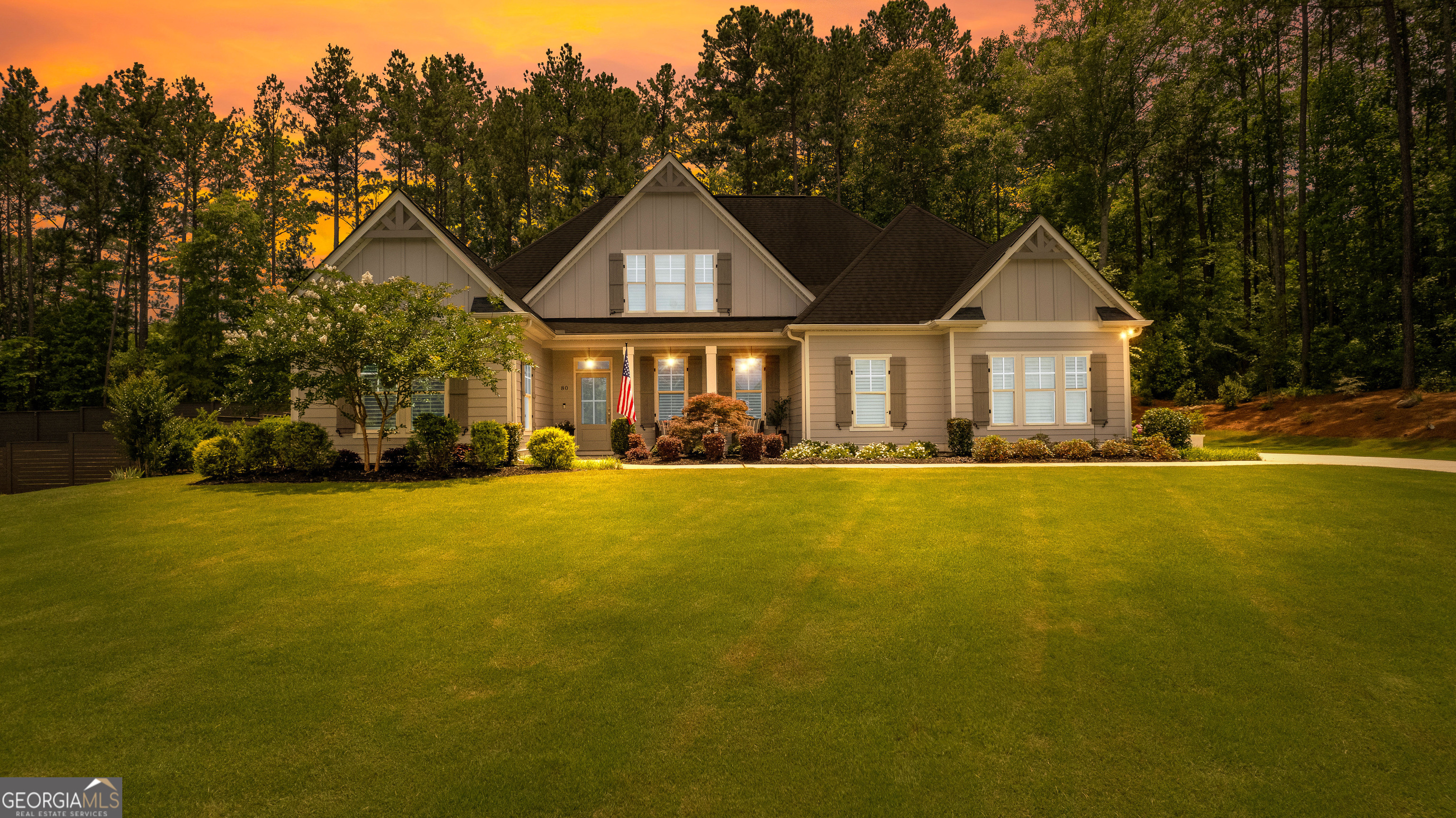 Welcome Home to Woodchase! Located just minutes from downtown Senoia, this exquisite ranch-style home is nestled in a quiet cul-de-sac and filled with high-end finishes and thoughtful design. A charming rocking chair front porch welcomes you into the home, where you will find beautiful hardwood floors throughout the main level and a spacious family room with a vaulted ceiling, custom accent wall, and cozy fireplace. The open-concept layout flows seamlessly into the gourmet kitchen, which boasts a large island, premium appliances, and a warm keeping room featuring a second fireplace and stunning wood-accented ceiling. This thoughtfully designed split bedroom plan offers privacy and functionality, with the primary suite and two additional bedrooms located on the main level, and a fourth bedroom and full bath upstairs-perfect as a guest suite, bonus room, or home office. The luxurious primary bathroom features double vanities, marble countertops, a separate tiled shower, and a relaxing soaking tub-creating the perfect retreat at the end of the day. Enjoy meals and gatherings in the separate formal dining room, ideal for hosting special occasions or casual get-togethers. Step outside to a true backyard oasis. The expansive covered porch overlooks the professionally landscaped yard-an ideal space to relax and unwind. Additional features include plantation shutters throughout the home, offering both elegance and privacy, as well as thoughtful architectural details throughout. This home truly has it all. Do not miss your chance to own this beautiful retreat in one of Senoia's most desirable neighborhoods!