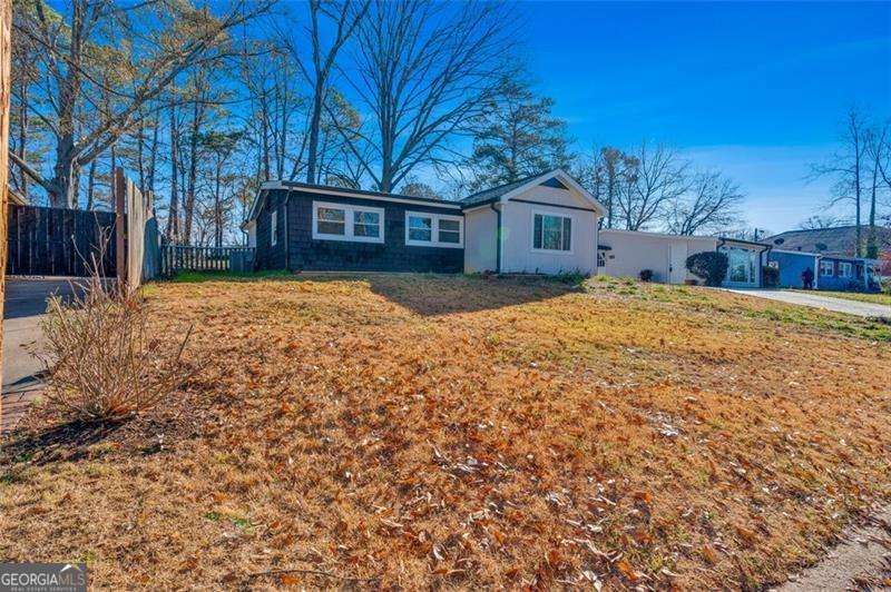 This is a Great Investment with a Complete Update! Wonderful open floor concept with a grand living room and exposed beams, 3 bedrooms with vaulted grand master suite, 2 full baths, brand new kitchen with top quality cabinets, quartz countertop, Whirlpool appliances, open pantry, W&D, new; roof, HVAC, Water heater and everything else. A detached additional room/workshop, and a beautiful backyard. It is the perfect location close to I-75, 41, and 120 loop and across from Kennesaw State UniversityCoThomas & Brown closing attorney. No HOA. This is an AMAZING investment home or office for this price range.