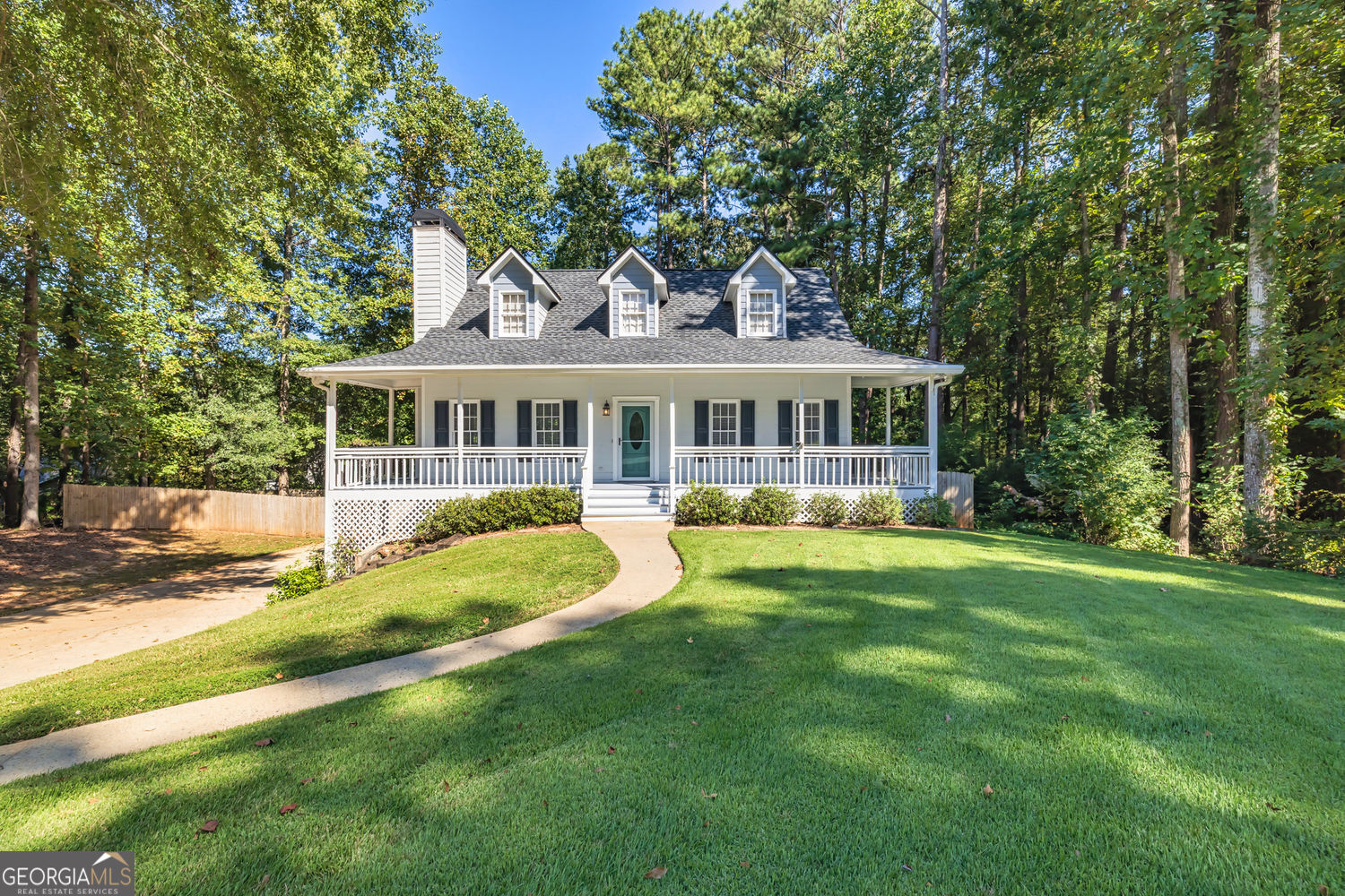 Adorable Cape Cod Charmer on a Quiet Cul-de-Sac - Perfectly positioned at the end of a peaceful cul-de-sac, this delightful Cape Cod-style home offers timeless curb appeal with a welcoming rocking chair front porch and a fully fenced backyard, ideal for relaxing or entertaining. Step inside to a cozy family room featuring a fireplace, an updated kitchen with a movable island, and a formal dining room for hosting guests. The main-level primary suite includes a walk-in closet and a private ensuite bath, providing comfort and convenience. Upstairs, you'll find two spacious secondary bedrooms and a beautifully renovated hall bath. The two-car drive-under garage offers ample space plus additional unfinished storage, perfect for future expansion or organization. Prime Location Close to top-rated schools, shopping, and easy interstate access, this home blends charm, functionality, and unbeatable convenience.