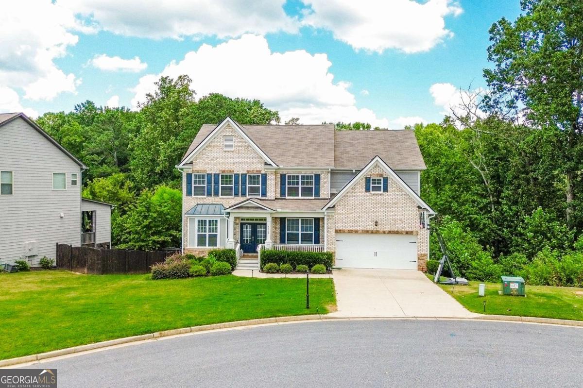 Step into this beautifully maintained 5 bedrooms, 4 bathrooms home nestled at the end of a quiet cul-de-sac, offering space, comfort, and style for modern living. As one of the few Fieldstone floorplans in the neighborhood, it boasts a soaring vaulted ceiling in the living room that instantly makes a grand impression. The home features an open layout ideal for entertaining, with a spacious stone kitchen island at its heart-perfect for casual gatherings or lively dinner parties. What makes this home even more attractive is the assumable mortgage at an incredibly low 4.2% interest rate-an exceptional opportunity in today's market, where average rates are over 6%. Inside, the owner's suite is a private retreat with elegant crown molding, French doors, and a generous sitting area. The custom-designed walk-in closet is thoughtfully built to accommodate an extensive wardrobe, including shoes, bags, and accessories. Upstairs, one bedroom enjoys its own bathroom and custom closet, while the remaining two bedrooms share a convenient Jack-and-Jill bathroom. A guest bedroom and full bathroom are also located on the main level, offering ideal accommodations for visitors or extended family. The finished basement expands your living space with a dedicated office, a movie room, a playroom, and a sprawling family room-perfect for work, relaxation, or recreation. Outside, enjoy the privacy of a large, level, fenced backyard-an ideal spot for pets, play, or simply unwinding under the sky. Located in the desirable West Forsyth school cluster and just minutes from Midway Park, Big Creek Greenway, Sawnee Mountain, YMCA, Vickery Village, and top shopping destinations, this home offers the complete package of location, lifestyle, and value. Come see it today before it's gone!