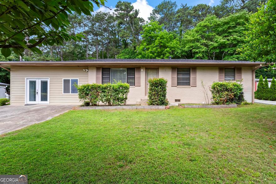 Renovated 4 bedroom, 3 full bathrooms, a second kitchen, and a converted garage ready for your home gym or for whatever extra space that may be on your needs list!  Beautiful hardwoods, an abundance of light, stainless steel appliances, and a large, level backyard are just some of the stand-out features of this home. Great for multigenerational living with one bedroom, bath, and kitchen tucked in the back of the house. This property offers plenty of parking in the long, level driveway as well as a second parking pad for your RV or boat. Fantastic home for putting down roots  or perhaps your next investment property.  Easy access to the interstate in this super convenient Marietta location.