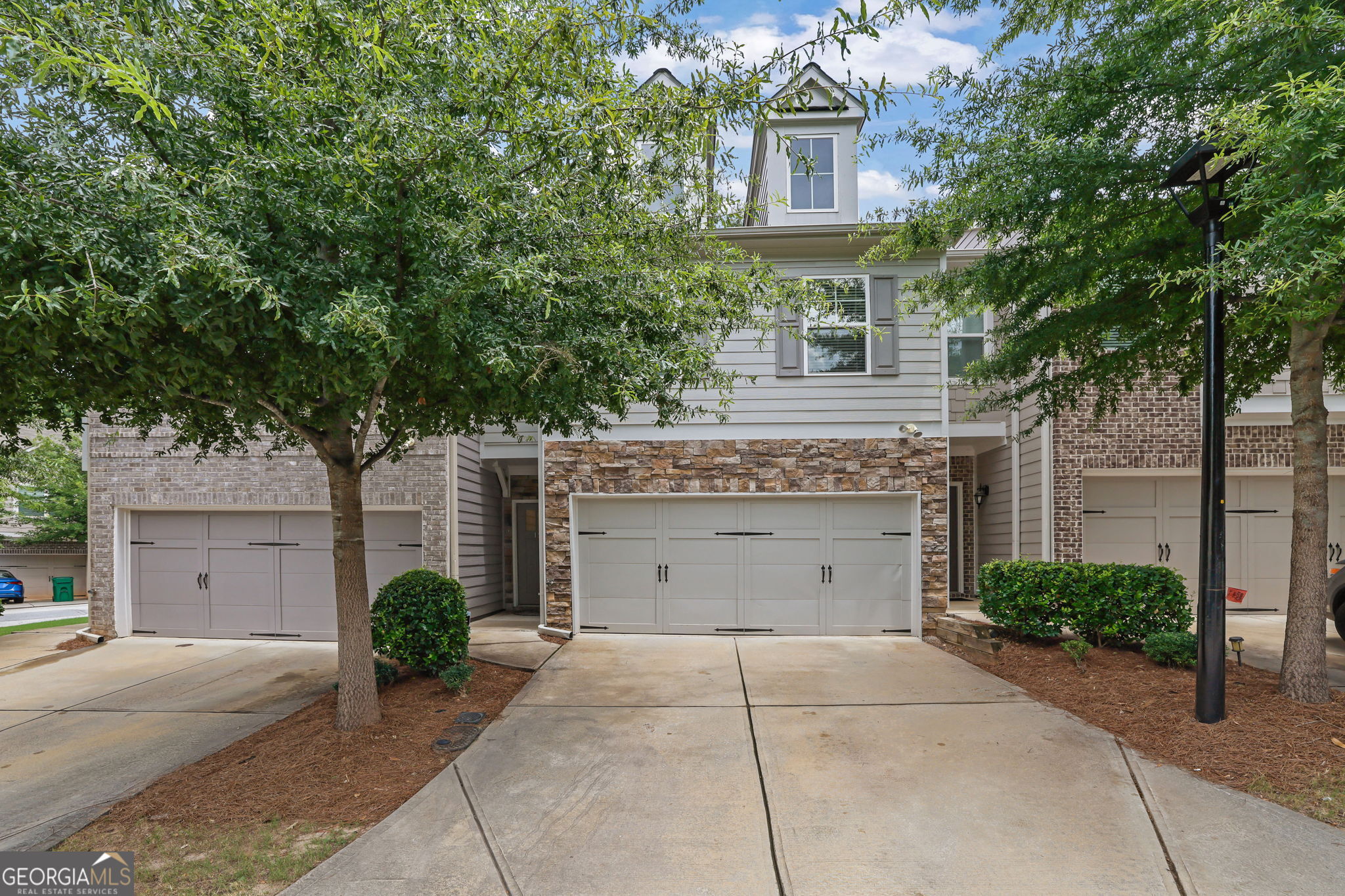 Welcome to this beautifully maintained and like-new townhome located in the City of Tucker-just minutes from everything Tucker, Stone Mountain, and the surrounding areas have to offer. Whether you're commuting into the city, enjoying local parks, or grabbing dinner nearby, the location is unbeatable. Step inside to find a light-filled open-concept main level with tall ceilings, sleek engineered flooring, and a seamless flow from the living area to the kitchen. The spacious family room features a cozy fireplace-perfect for gathering or unwinding-and opens to a modern eat-in kitchen designed for both everyday living and entertaining. Enjoy stainless steel appliances, stone countertops, a stylish tile backsplash, an oversized island with seating, and generous cabinet space including a walk-in pantry. Upstairs, a flexible loft area provides the perfect bonus space for a home office, reading nook, or play area. The large primary suite is a true retreat with a trey ceiling, walk-in closet, and spa-style ensuite bath featuring a dual vanity, garden tub, and separate tile shower. Two additional bedrooms, a full hall bath, and a convenient upstairs laundry room round out the second level. Outside, step onto your private patio with a fenced backyard-ideal for relaxing with your morning coffee, grilling with friends, or letting pets play freely. Additional perks include a 2-car garage with direct entry, low-maintenance living with exterior upkeep handled by the HOA, and easy access to Stone Mountain Park, Hwy 78, I-285, shopping, dining, and more. This is the one you've been waiting for-modern, move-in ready, and low-maintenance with thoughtful touches throughout. Come see it for yourself!