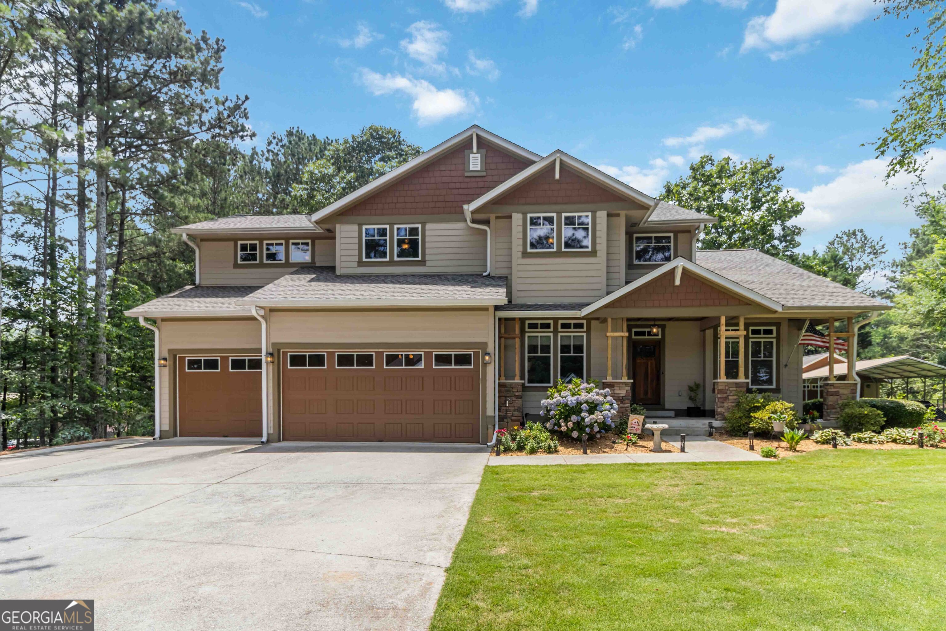 Welcome to this beautiful Craftsman custom-built home on coveted Harris Road in Lawrenceville. Come see your dream home ready to move in with new roof, new paint, new A/c units, new 75-gallon water heater and much more. This gorgeous and private property features a 5,280 square-foot house, a 3-car attached garage, a workshop (with 100 amps) or use as additional 2-car garage, a large carport, and a shed. The house boasts 3-levels with plenty of living space for family and friends. As you come up to the house, you are welcomed by a spacious front porch featuring stone and wood columns. Step into the stunning 2-story foyer where you find white oak hardwood floors, a beautiful wood staircase and many custom-wood details such as a mahogany front door, red oak doors, white oak flooring, custom craftsman trim and gorgeous stained-glass lighting throughout the whole house. The main level features an open living room with a wood-burning fireplace, a breakfast area, a sun/reading room, and a spacious, well-equipped dream kitchen with Merrilat Masterpiece oak cabinetry with soft-close drawers, Cosentino Quartz countertops, and stainless steel appliances. The kitchen has a sprawling island for meal prepping and entertainment. Andersen casement windows throughout the whole house let in lots of light and provide a view of the fenced in backyard and covered composite deck with pull down tv. Right off the kitchen you will find the formal dining room, and a cozy tv/ reading room. The dining room has a gorgeous stained-glass window, coffered ceiling and custom room dividers. Go through the French doors of the sitting area to the upstairs where you will find 3 bedrooms, the laundry room and the Owner's Suite. The Owner's Suite offers a quiet retreat with a cozy sitting area, walk-in closets and an ensuite bathroom with shower and soaking tub. As you go downstairs, you can admire the ample space and beautiful details the welcoming foyer provides. The finished terrace level is ready for your entertainment. This level boasts a home theater with custom-built-in cabinetry for storing board games, crafts, video games, etc. This fun area of the house has a pool table with a gorgeous billiard light and a kitchenette with seating area. This one-of-a-kind custom-built home is located on a quiet street yet it is within minutes of parks, restaurants, schools, major roads, and much more.