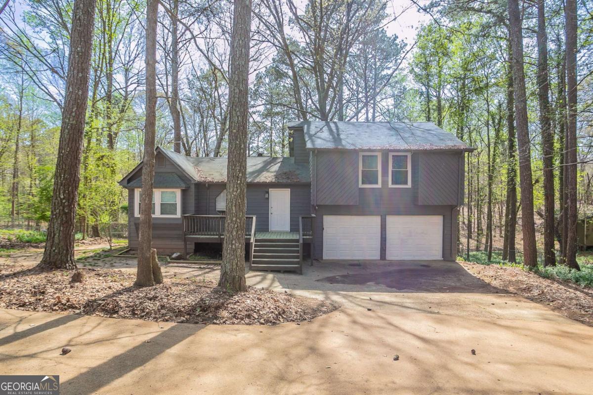 This multi-level home offers a perfect combination of comfort and charm with 3 bedrooms and 2 bathrooms. The spacious living room features a cozy fireplace, making it an ideal space for relaxation or entertaining. The home also boasts a front wood deck, perfect for enjoying the outdoors. In the backyard, you'll appreciate the peaceful view of the trees, providing a serene retreat. A chain link fence adds privacy and security, and the double vanity in the bathroom offers added convenience. Additional storage is available with a shed, and the 2-car garage provides ample parking and extra storage space. Don't miss out on this wonderful home. Schedule your showing today!