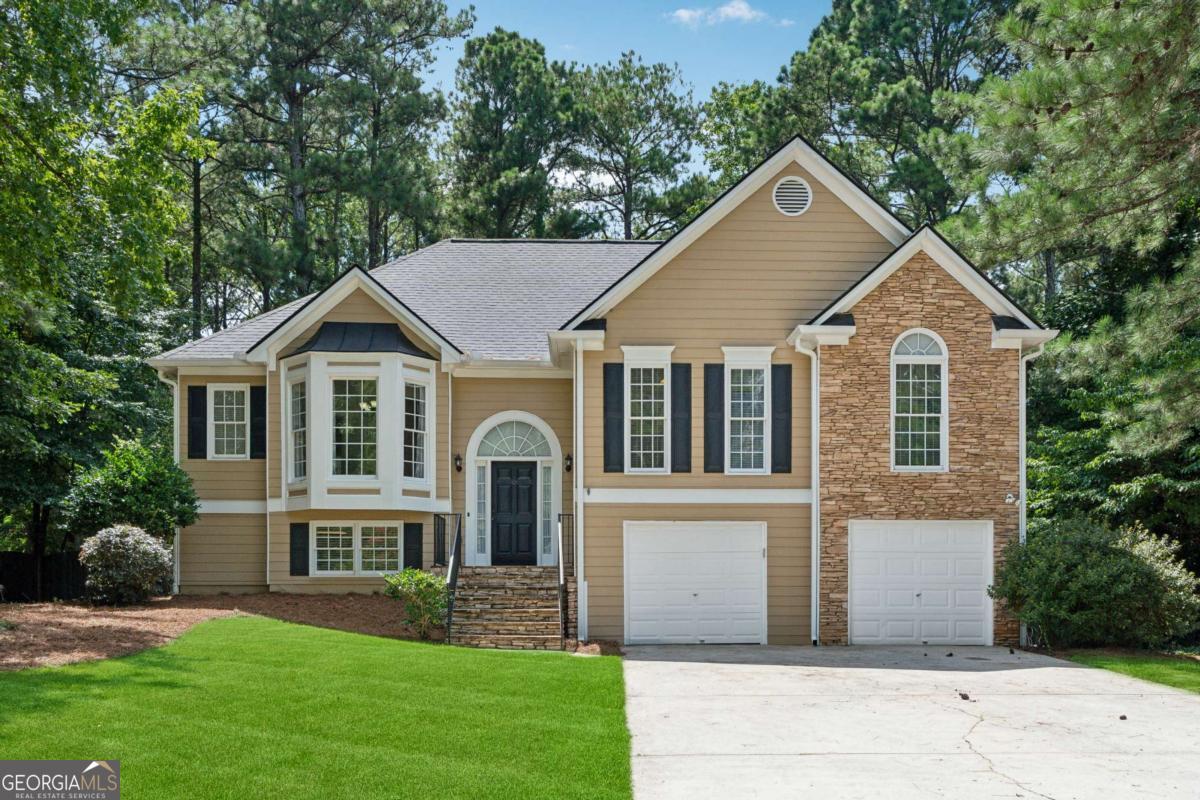 Nestled in a quiet cul-de-sac in the sought-after North Paulding school district, this 4 bedroom, 3 bathroom split-level home combines thoughtful updates with flexible living space. On the main level you'll find an oversized primary suite complete with a dedicated office/sitting area. Hardwood floors that flow throughout the open concept kitchen, dining room and family room. Step outside onto the brand-new deck overlooking a spacious, privacy-fenced backyard-ideal for summer barbecues or morning coffee. The fully finished lower level offers new carpeting, a bright fourth bedroom and a full bath-perfect for guests, in-laws or a home gym. Appliances including stove, microwave, dishwasher and refrigerator convey, and two HDTVs remain will in the upstairs bedrooms for added convenience. Get ready to enjoy fall evenings by the fireplace with a gas log starter. Major systems were all replaced in 2021: a new roof, Goodman HVAC and hot-water heater ensure worry-free living. Low HOA dues - only $190 per year. Schedule your private showing today and discover all this home has to offer!