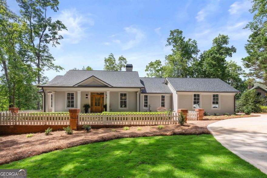 Welcome to Great Waters at Reynolds Lake Oconee.  This lakefront, ranch home enjoys TWO primary, lakefront bedrooms with ensuite baths.  Walk through the front entry and take in the lake views through the living room.  Open, eat-in chef's kitchen with bay window, walk-in pantry, 2 additional bedrooms with an additional full bath... The list of new items goes on & on... paint, floors, windows, doors, kitchen, baths, lighting, covered porch with extended roofline, landscaping, driveway...  Another bonus... Max dock with deep water and boat lift.  Membership right available, should you choose to take advantage of award winning golf, restaurants, pools, spa, entertainment, fitness, tennis, ziplining and ... falconry.   Yes.. falconry...  Living here is better than going on vacation!