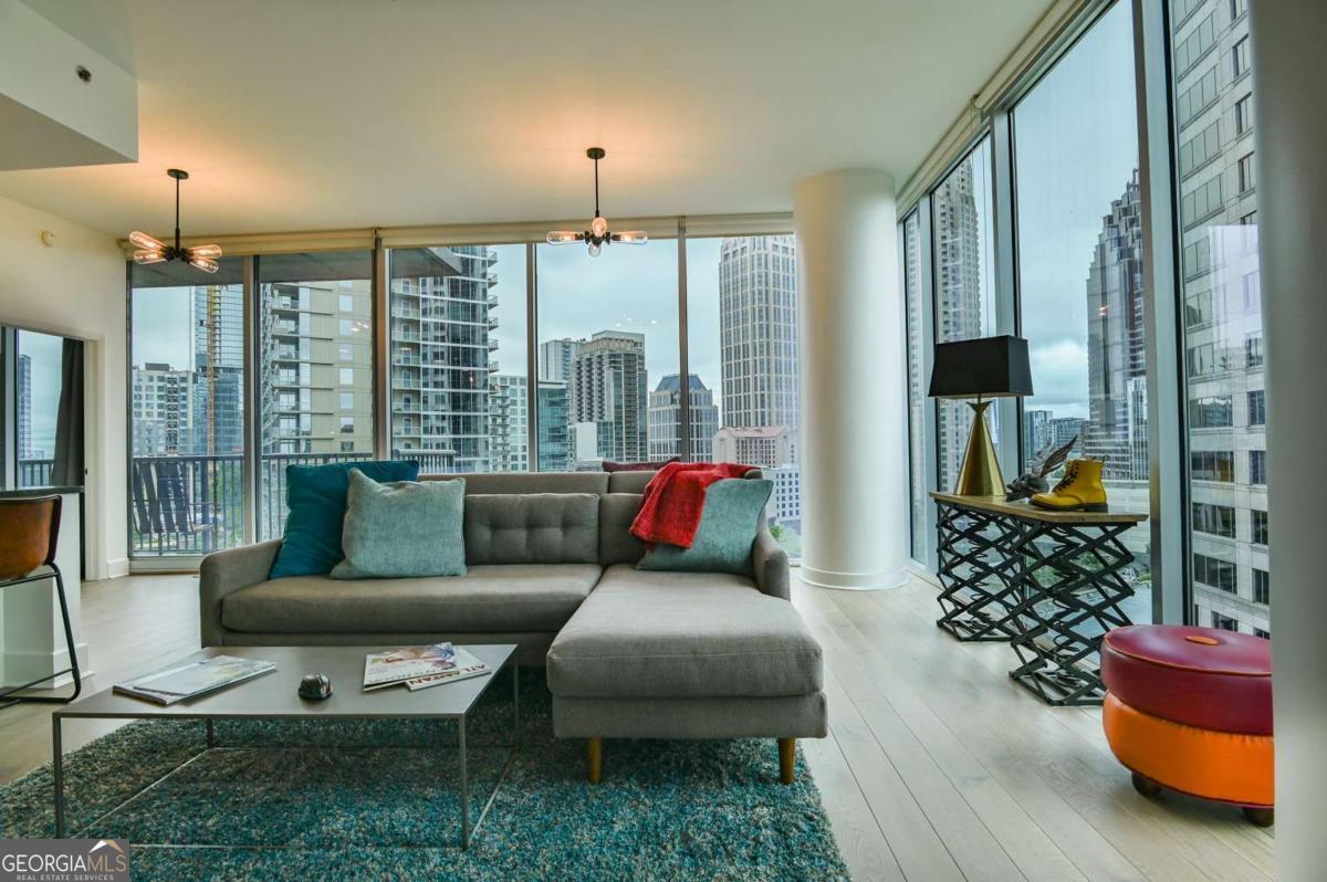 Stunning Midtown Condo with Panoramic Views Welcome to this beautiful corner unit offering sweeping 180 views in one of Midtown Atlanta's most desirable buildings. This spacious two-bedroom, two-bathroom condo features a modern open-concept layout, with new hardwood flooring and fresh designer paint throughout. The building offers resort-style amenities, including a sky park and pool, a newly renovated fitness center, and an elegant lounge and club room. Additional features include gated, covered parking with two dedicated spaces and 24/7 concierge service for your comfort and security. Located just steps from premier dining, upscale shopping, and the scenic Piedmont Park, this home offers unmatched walkability. Enjoy easy access to the Atlanta BeltLine and Marta station (just one block away), providing a direct, convenient commute to the airport, downtown ATL and Buckhead. Midtown is home to Atlanta's top cultural destinations, including the Fox Theatre, Atlanta Symphony Orchestra, the High Museum of Art, and a vibrant nightlife scene. Don't miss the opportunity to live in the heart of Midtown with every convenience and cultural highlight at your doorstep.