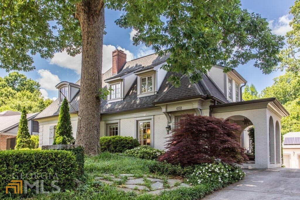 Enchanting, solar-powered 1920's French-Provincial home tucked above one of Morningside's most coveted streets. Exceptional, newer renovation weaving period details with modern luxuries that include: true chef's kitchen with venetian plastered walls, 48" Wolf gas range 6-burners/griddle/dual ovens, honed-marble island, soapstone counters, full-size column refrigerator & separate freezer, two marble & stone baths. Serene 2nd level owner's retreat features sitting area with picture window and views of trees/rear garden, an alluring spa bath with soaring, vaulted ceiling, soaking tub & separate shower. Beautiful, customized closet complete with built-in dressers and extra storage. Newer energy-efficient HVAC systems, spray foam insulation in attic & basement, encapsulated basement, huge compost bin and solar panels with back-up battery (purchased by seller). Unused energy can be sold at retail value back to GA Power! Large fireside living room plus separate den with custom bookshelves and French doors that lead to expansive and partially covered IPE rear deck. Private, fenced backyard with electronic iron gate is poised for pool. Oversized, insulated & conditioned detached 2-car garage. A truly idyllic home where every room beams with natural light and personality, and where beauty meets sustainability. Located within walking distance to Piedmont Park, Morningside Nature Preserve, Ansley Mall, Atlanta Beltline and so much more. #LOVE652cumberlandcir #whereeverydayisearthday