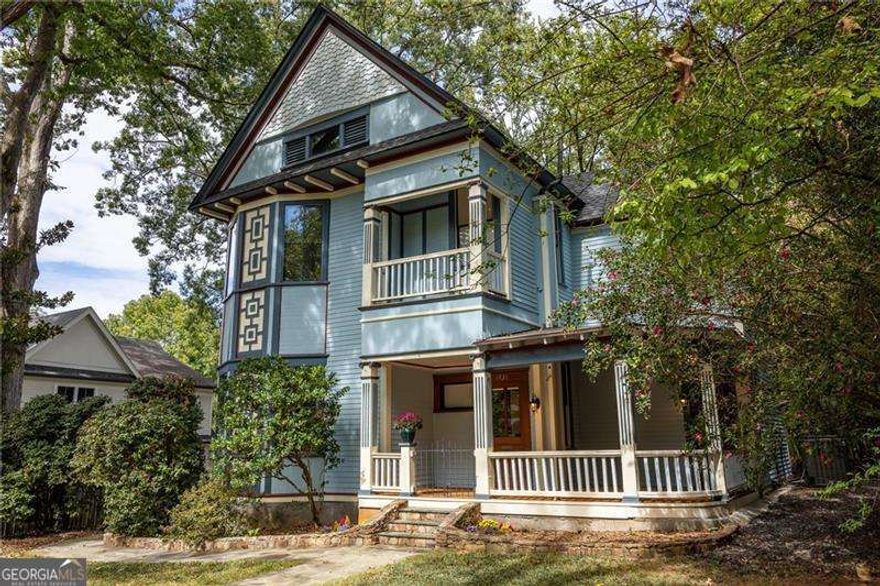 Step into a world of timeless luxury in the heart of Candler Park, where historic Victorian charm meets refined modern living. Built in 1900, this beautifully preserved home welcomes you with a sweeping covered front porch, a signature element of classic Candler Park architecture, perfect for morning coffee or evening unwinding as the neighborhood comes to life. Inside, original craftsmanship shines through in every detail, from intricate woodwork to soaring ceilings and five original fireplaces that fill the home with warmth and character. Fresh paint, newly refinished floors and modern light fixtures brighten every space, giving this Victorian a fresh yet timeless glow. A large living room with a gas fireplace sets the stage for both lively gatherings and cozy movie nights, while the oversized dining room is ideal for hosting the ultimate Friendsgiving feast with family and friends. The renovated chef's kitchen showcases Viking appliances, marble countertops, custom wood cabinetry and French doors that open to the outdoor patio for effortless entertaining. An expansive kitchen and mudroom with abundant storage make everyday life both beautiful and organized. Upstairs, the primary suite is a true sanctuary with a private portico overlooking McLendon Avenue and a spa-style ensuite bath, offering a luxurious escape from the bustle of everyday life. Two additional bedrooms and a versatile bonus space provide room for work, creativity or relaxation, all wrapped in historic charm. The backyard is a private oasis designed for both leisure and entertaining. Lounge in a shaded hammock, host dinners on the patio or watch children enjoy the custom playground set, all behind an iron security gate with an electronic entry system for privacy and convenience. A full-size attic offers room to expand and the property's R4 zoning allows for a guest house or pool, creating even more opportunity. This home has been thoughtfully updated with automatic Bali shades in every room, a new roof, new sewer and water lines with irrigation system, new plumbing throughout, a tankless hot water heater with surge line, completely updated electrical with upgraded 200 amp service and panel, and insulated storm windows. Steps from the neighborhood market, the home is central to parks and trails including Candler Park Pool and Golf Course, Olmsted Linear Park, Lake Claire Land Trust, Frazier Forest and the PATH trail which connects easily to the BeltLine, Mary Lin Elementary and Howard Middle.