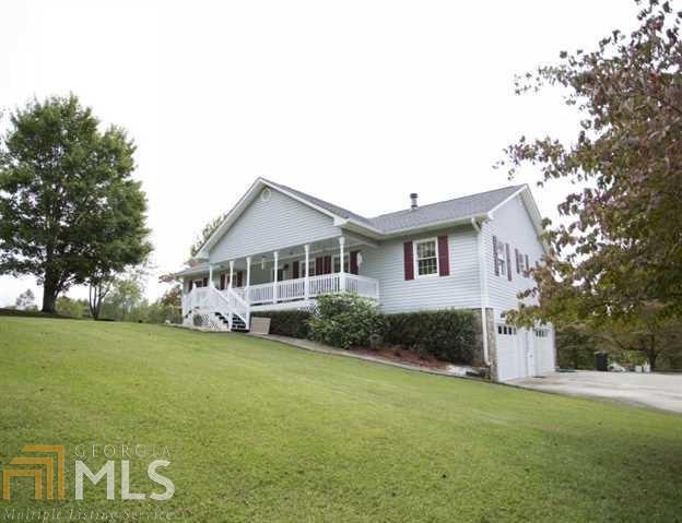Beautiful 3 Bedroom 2 Bath Traditional Home with Rocking Chair Front Porch on 9.43 acres of Serene Views, Open Floor Plan, Pellet Stove, Granite Kitchen Countertops, Backsplash and Hardwood Floors, Heated Swimming Pool, Jacuzzi and Gazebo in Fenced in Yard, US Steel Tractor Building built 2012, 2-year-old AC Unit, Two New Garage Doors, Bonus Room in Basement. A Must See!!!